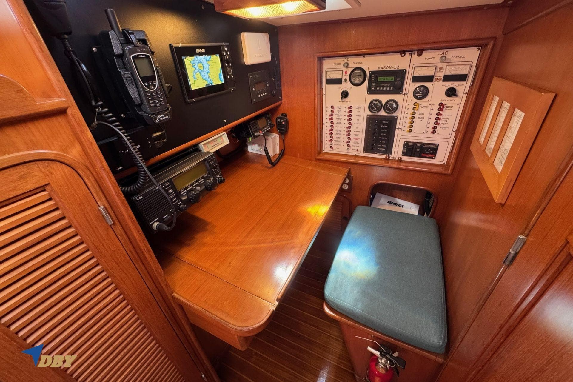 Navigation station of 1983 Mason 53 yacht with control panels and communication equipment.