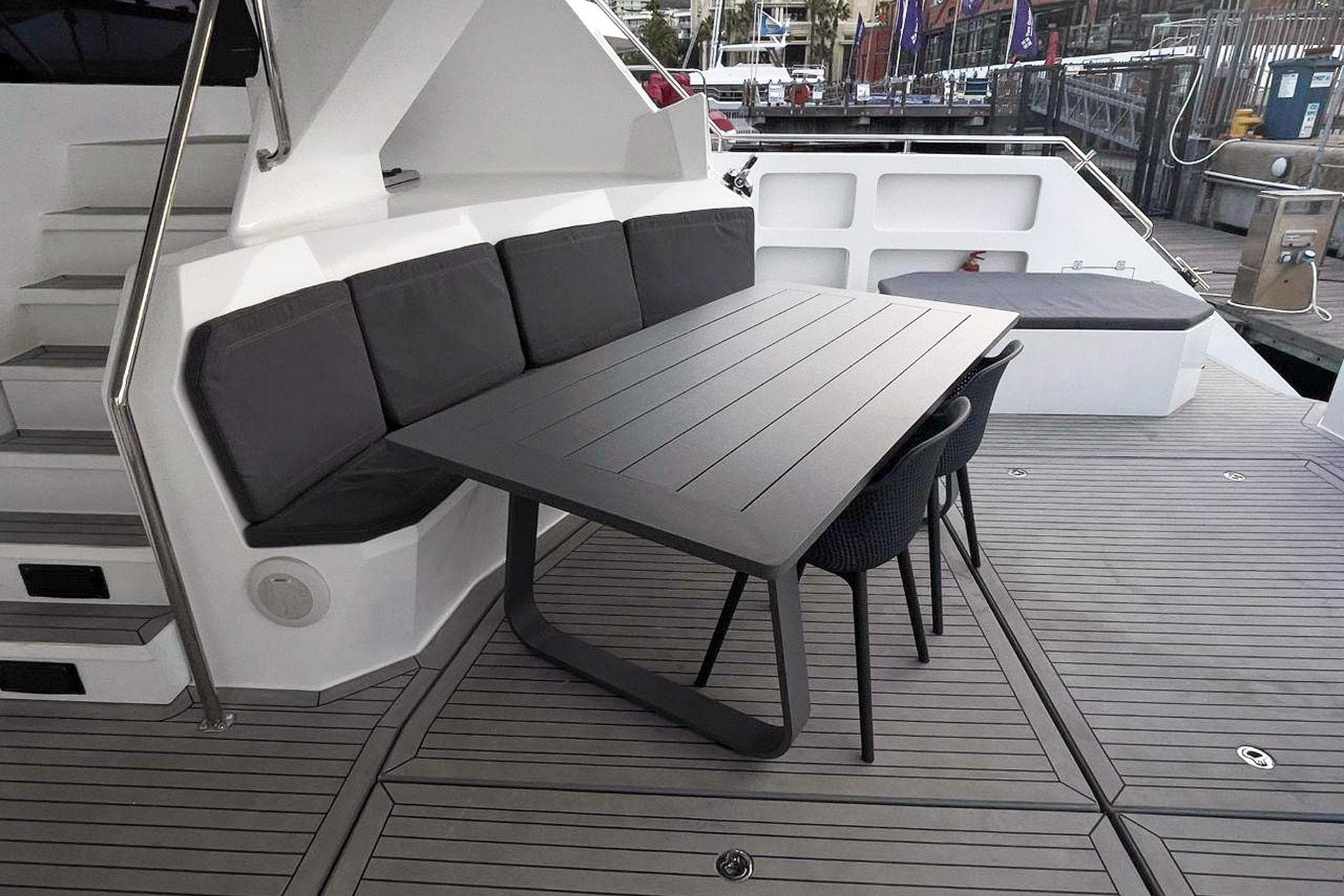 Deck area of Leeuwin 55 yacht, 2024 model, featuring table and seating.