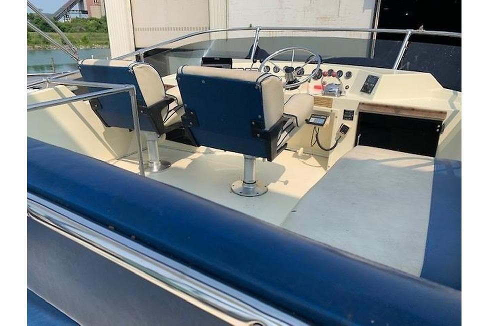 1986 Tollycraft 34 Sundeck boat interior with helm and seating area.
