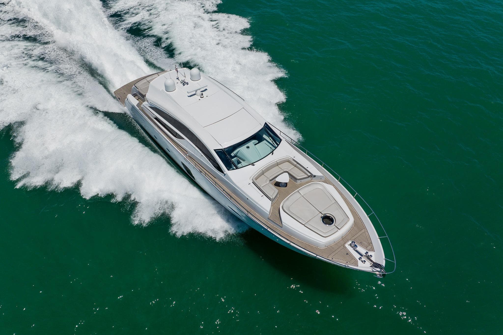 Luxurious 2010 Pershing 80 yacht cruising swiftly on open water.