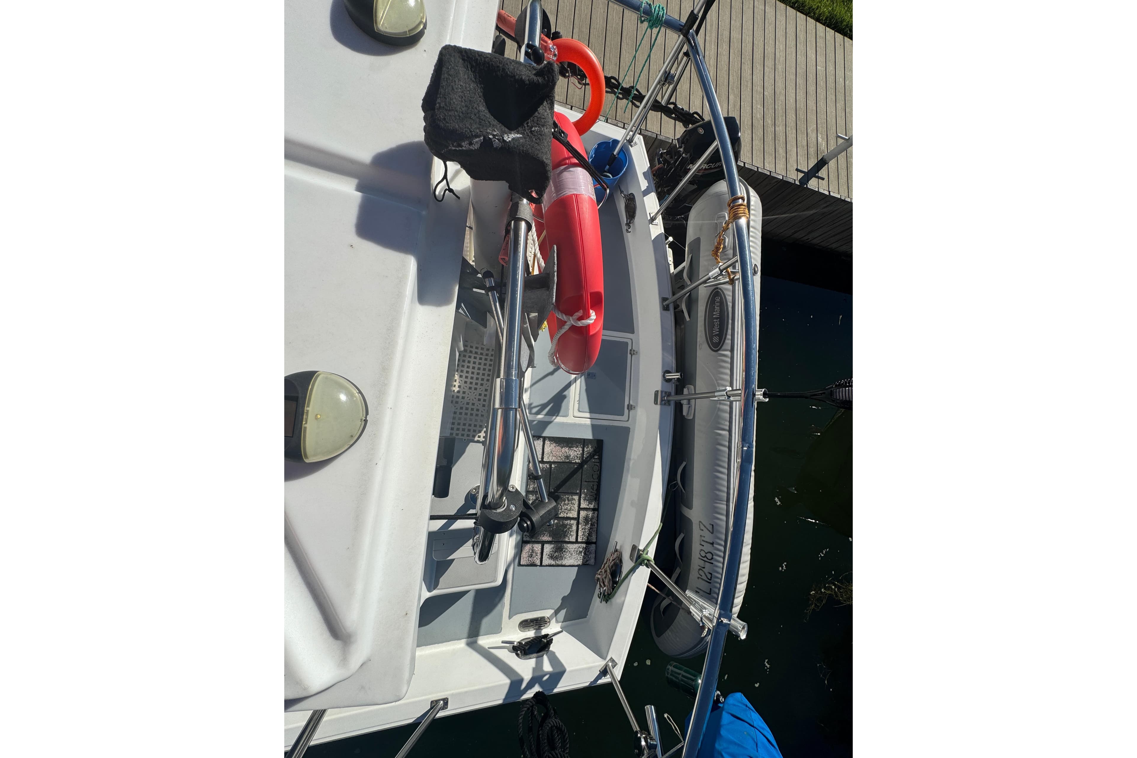 2001 Monk Trawler boat docked with safety equipment and inflatable dinghy.