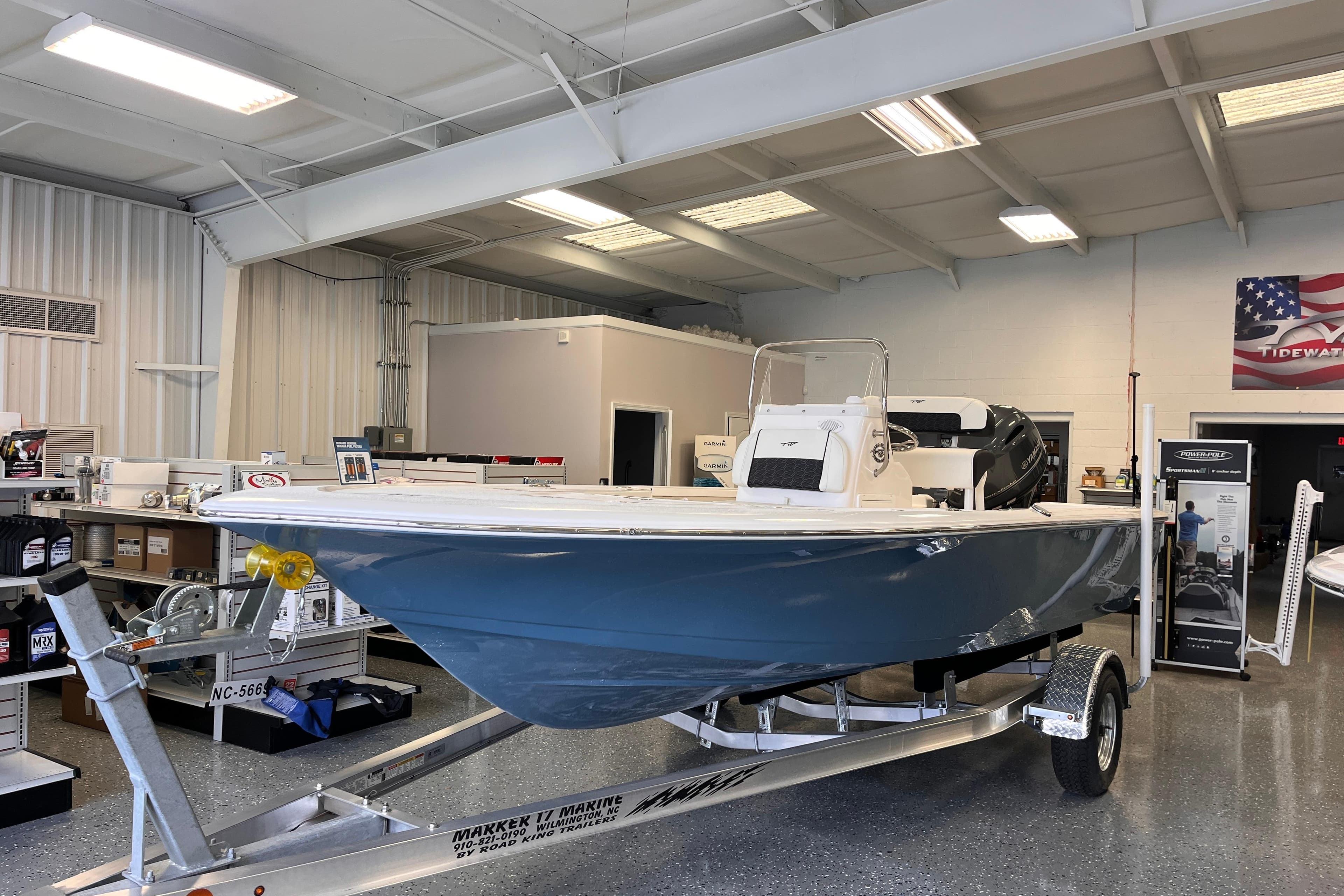 2026 Tidewater 1910 Bay Max boat displayed in showroom on trailer.