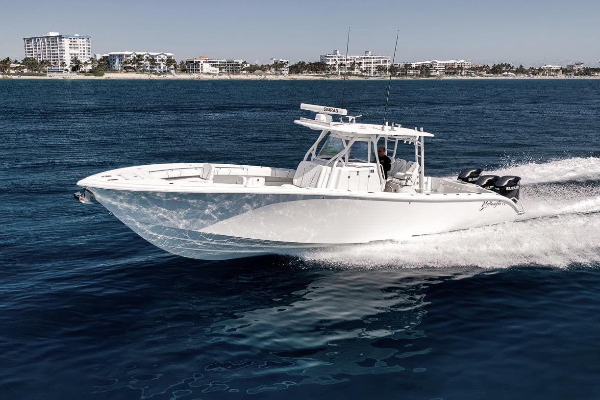2012 Yellowfin 39 Offshore boat cruising on open water near a coastal city.
