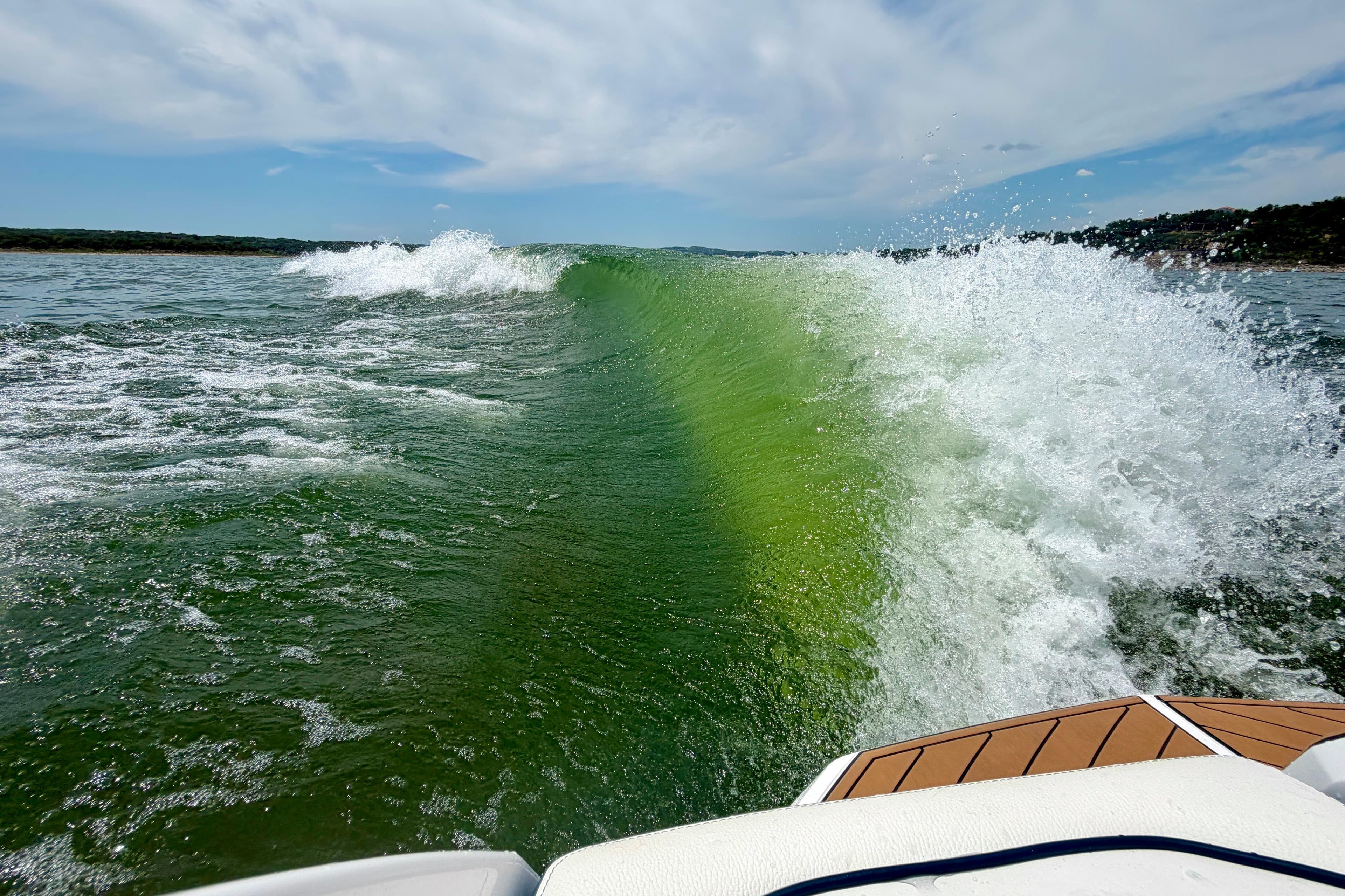 Wake created by 2022 Nautique Super Air Nautique GS24 on a sunny day.