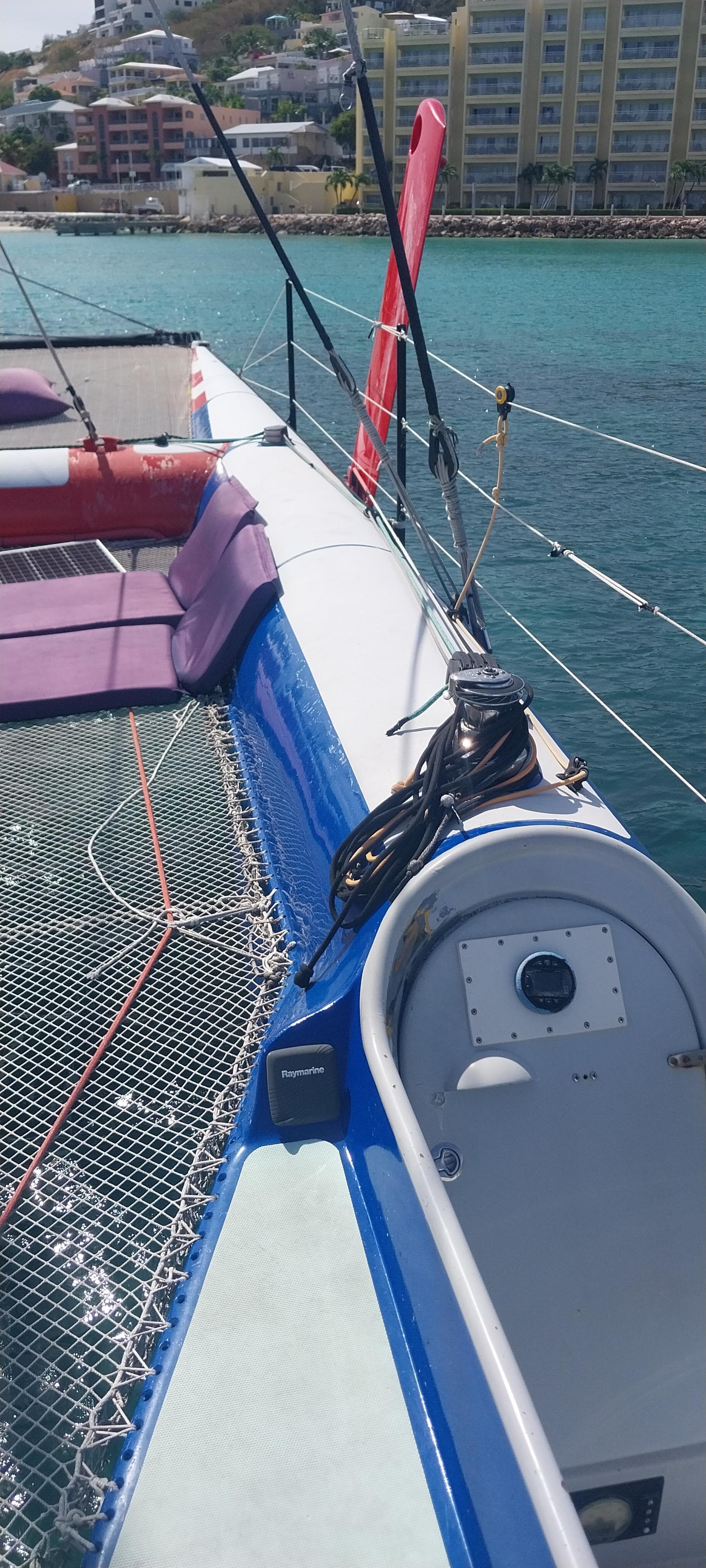 1997 Joubert-Nivelt 52 sailboat deck with netting and coastal background.