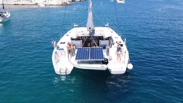 2021 Excess 11 catamaran with solar panels on blue ocean water.