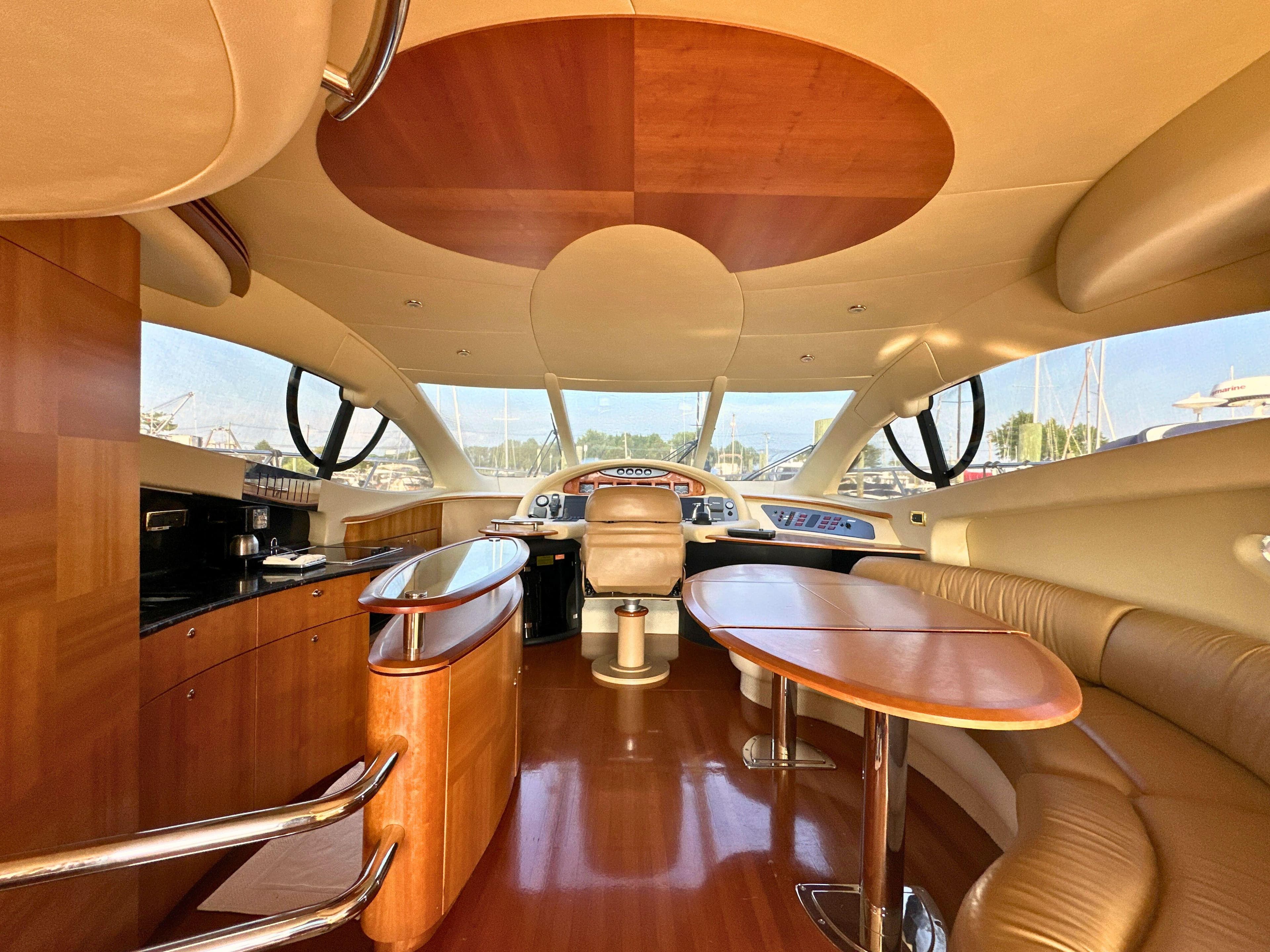 Luxurious interior of a 2010 Azimut 55E yacht with elegant wood finishes.