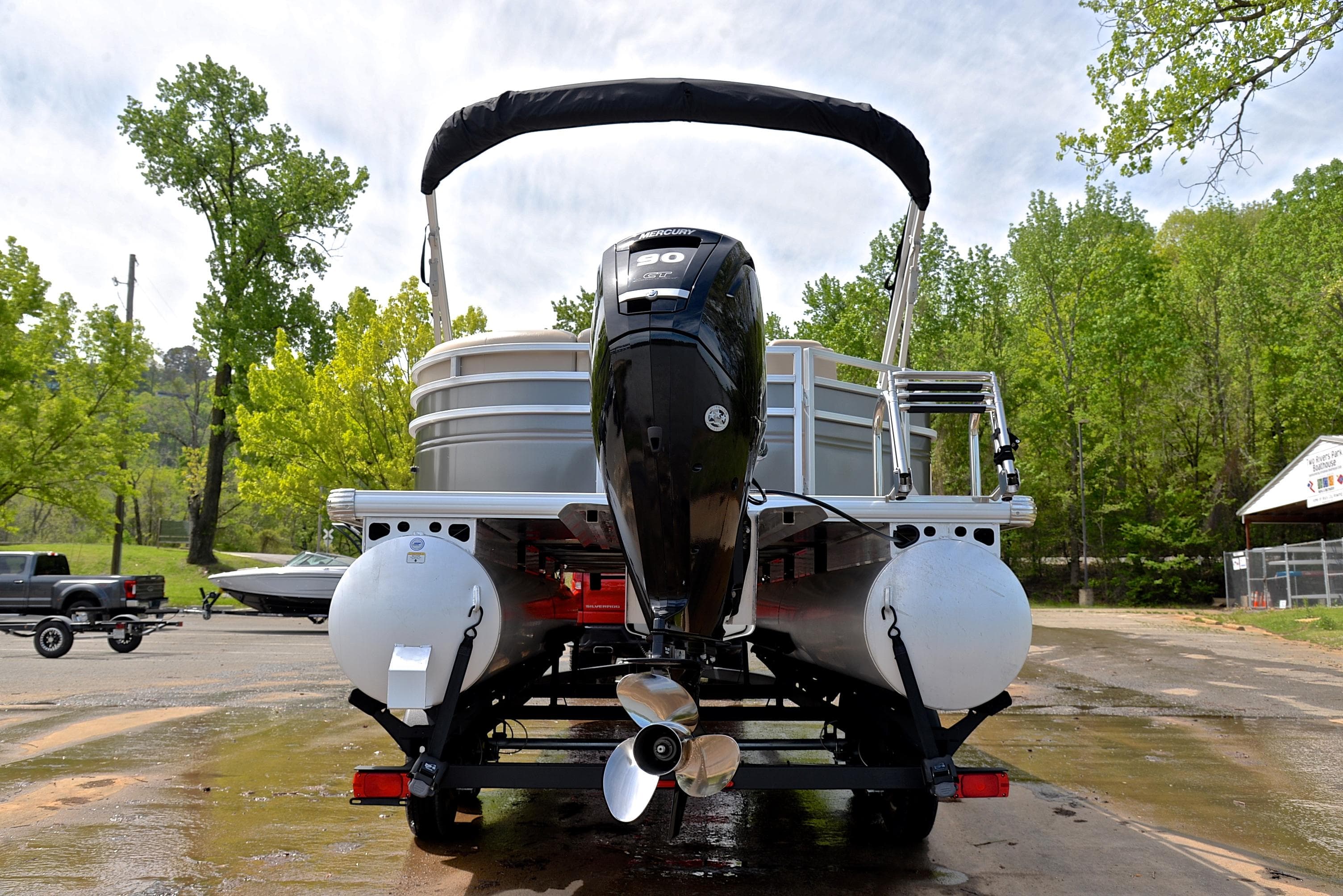 2024 Sun Tracker Party Barge 20 DLX pontoon boat on trailer, rear view.