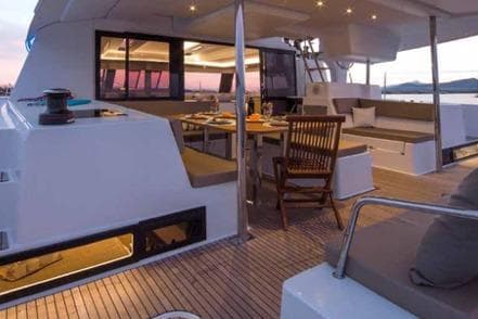 2019 Fountaine Pajot SABA 50 yacht with elegant outdoor dining area at sunset.
