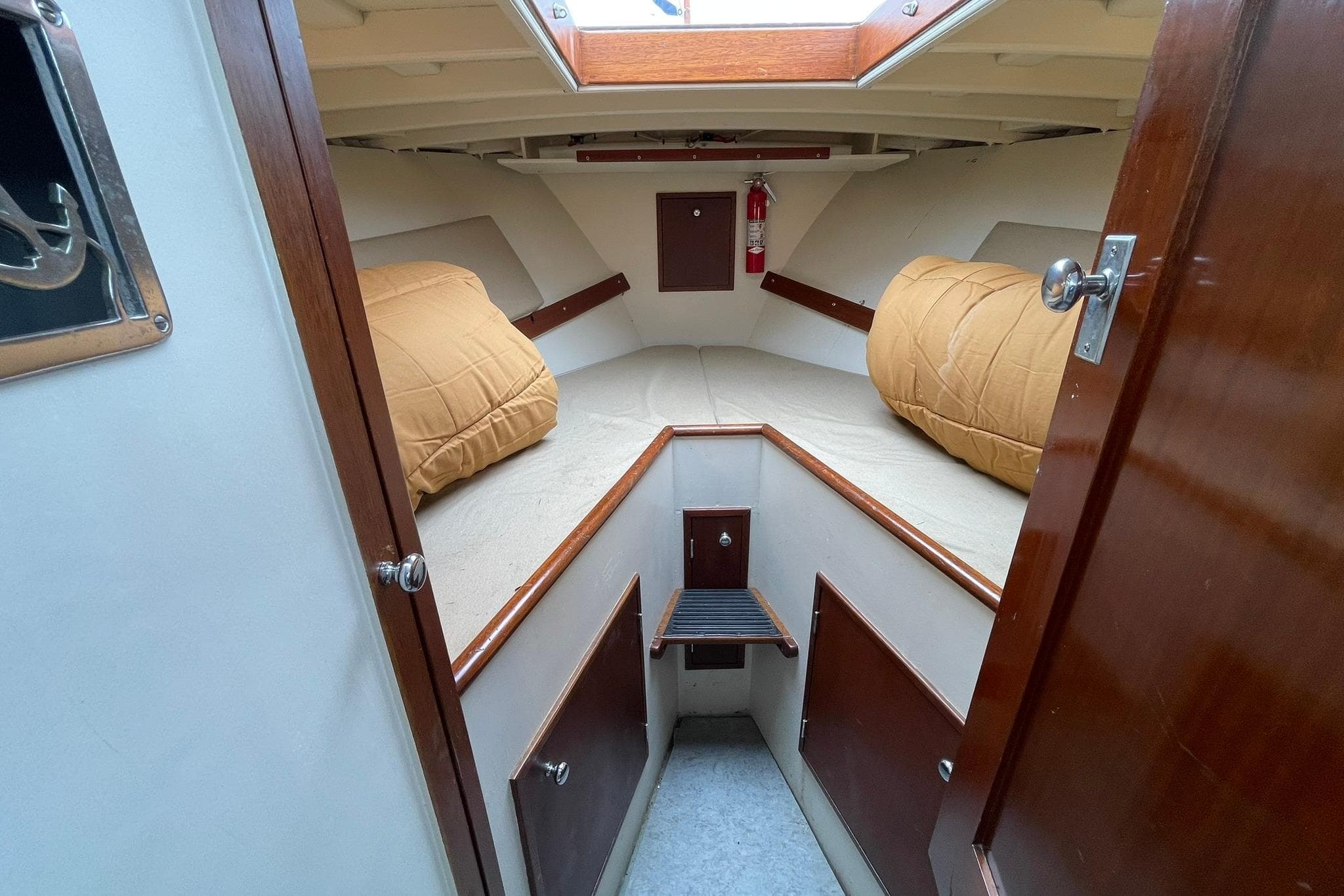 1948 Grandy 34 boat cabin interior with cozy bedding and wooden accents.
