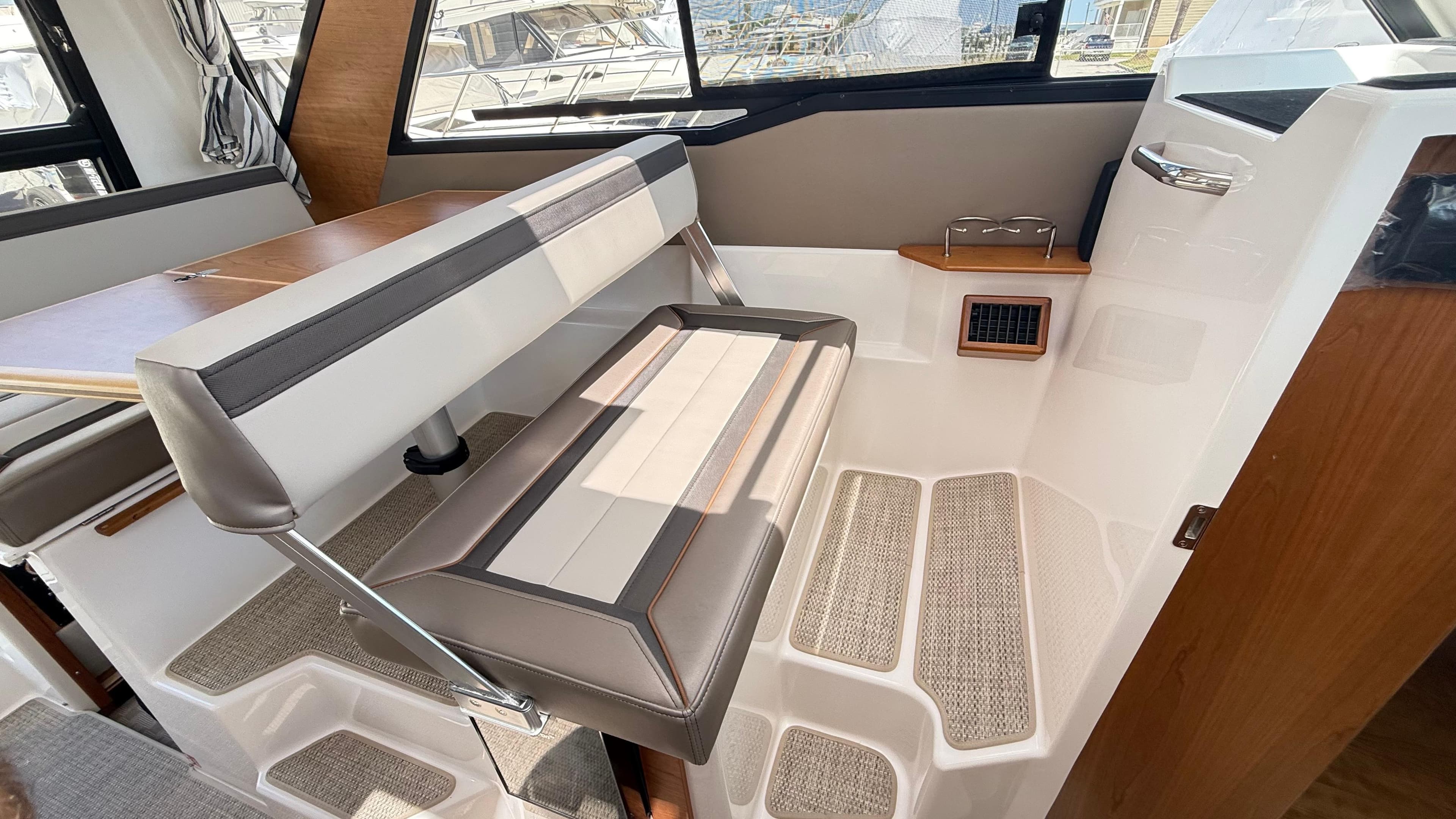 2026 Cutwater C-288 Coupe interior seating with table and window view.