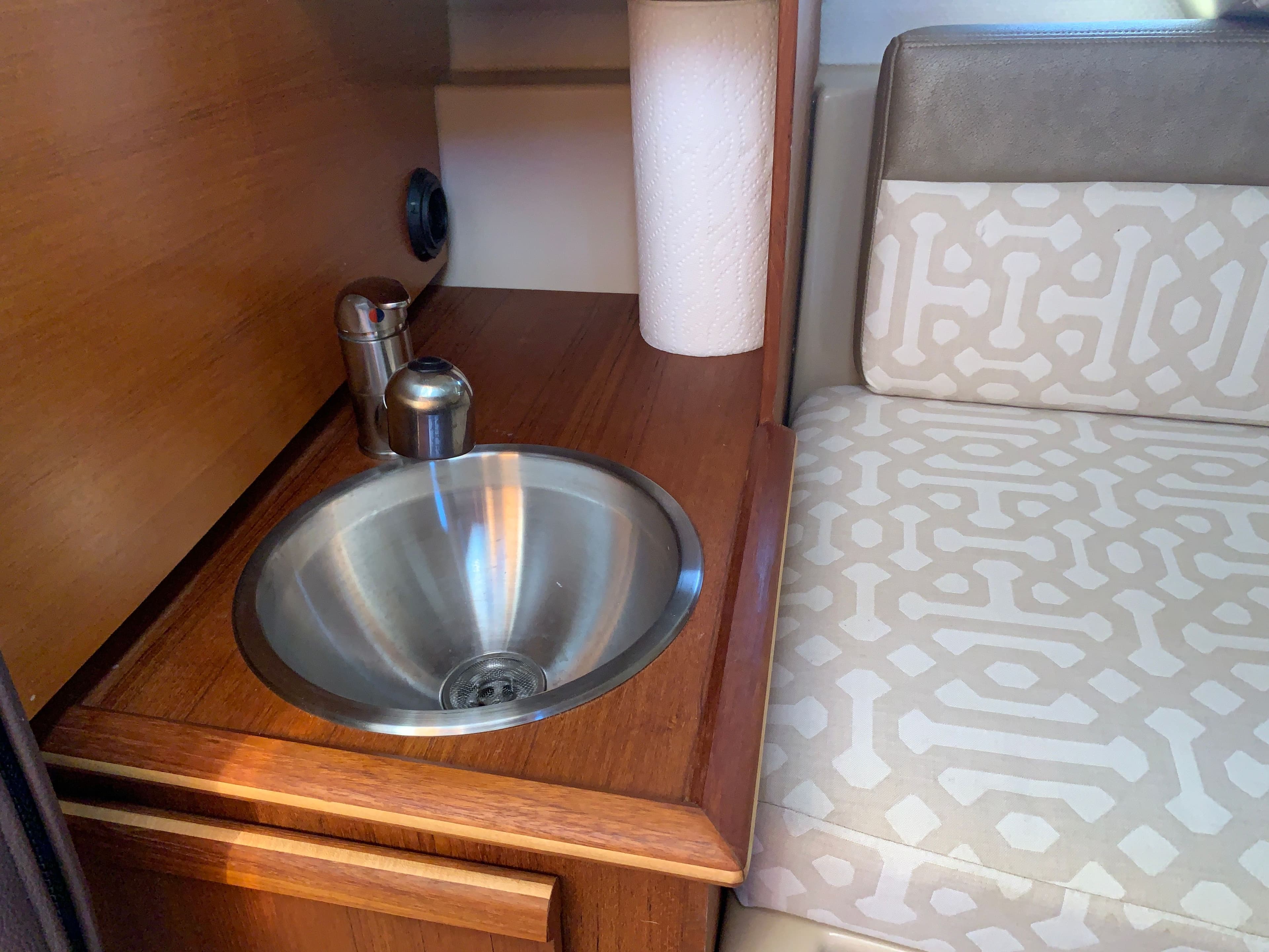 Interior of 2018 Ranger Tugs R-23 with sink and seating area.