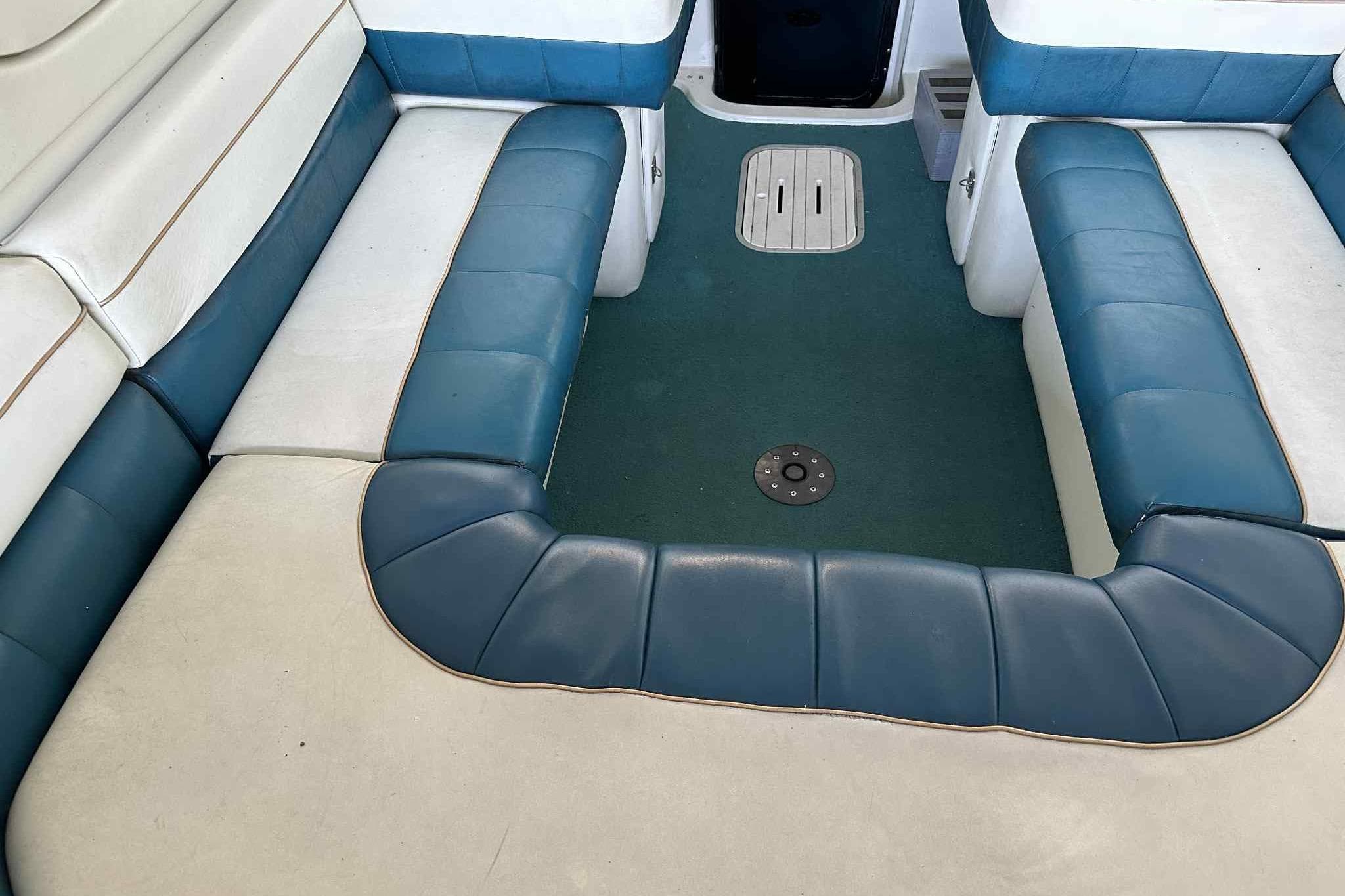 Interior seating of a 1995 Genesis Boats 2505, featuring blue and white upholstery.