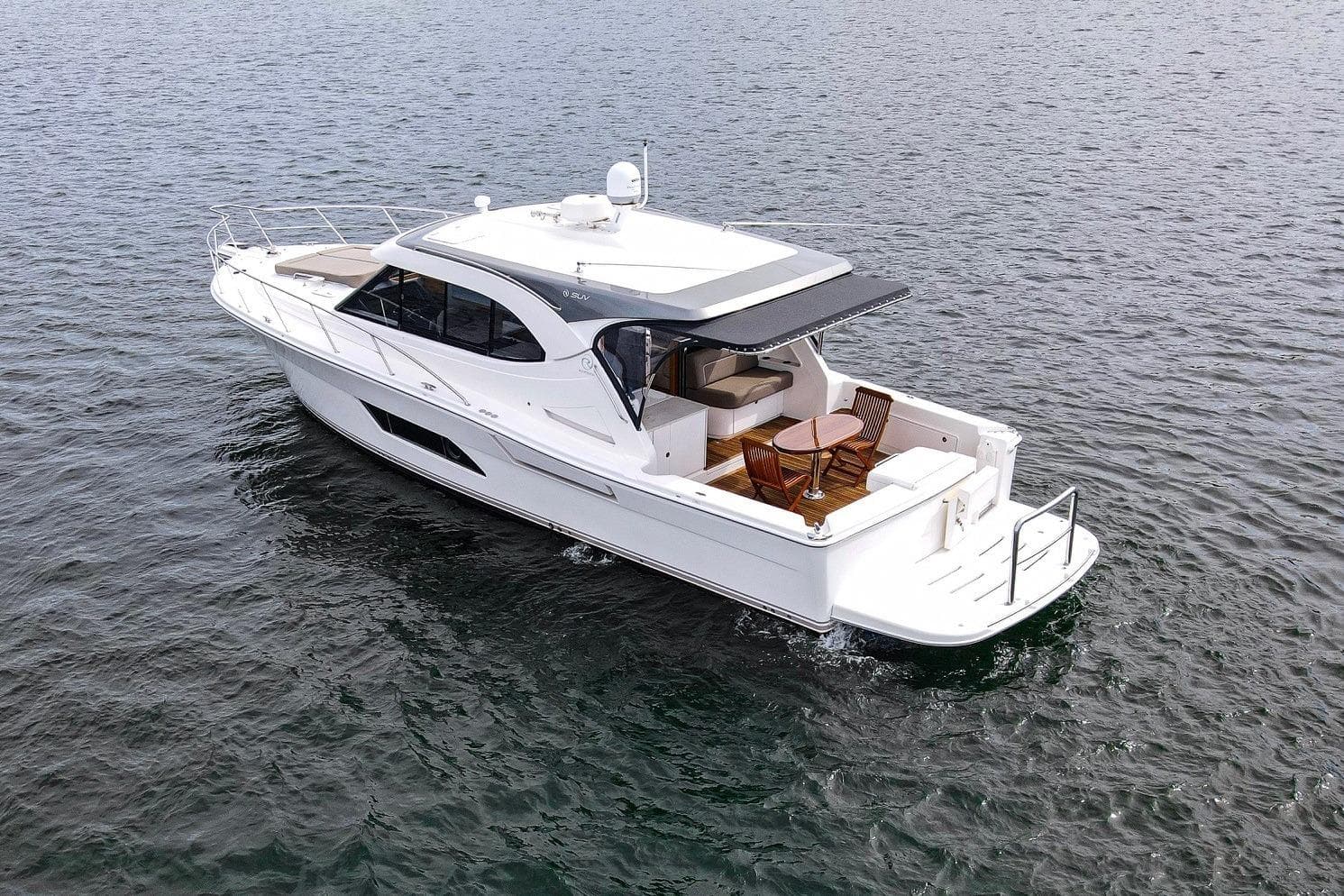 2016 Riviera 445 SUV yacht cruising on open water, featuring sleek design and spacious deck.