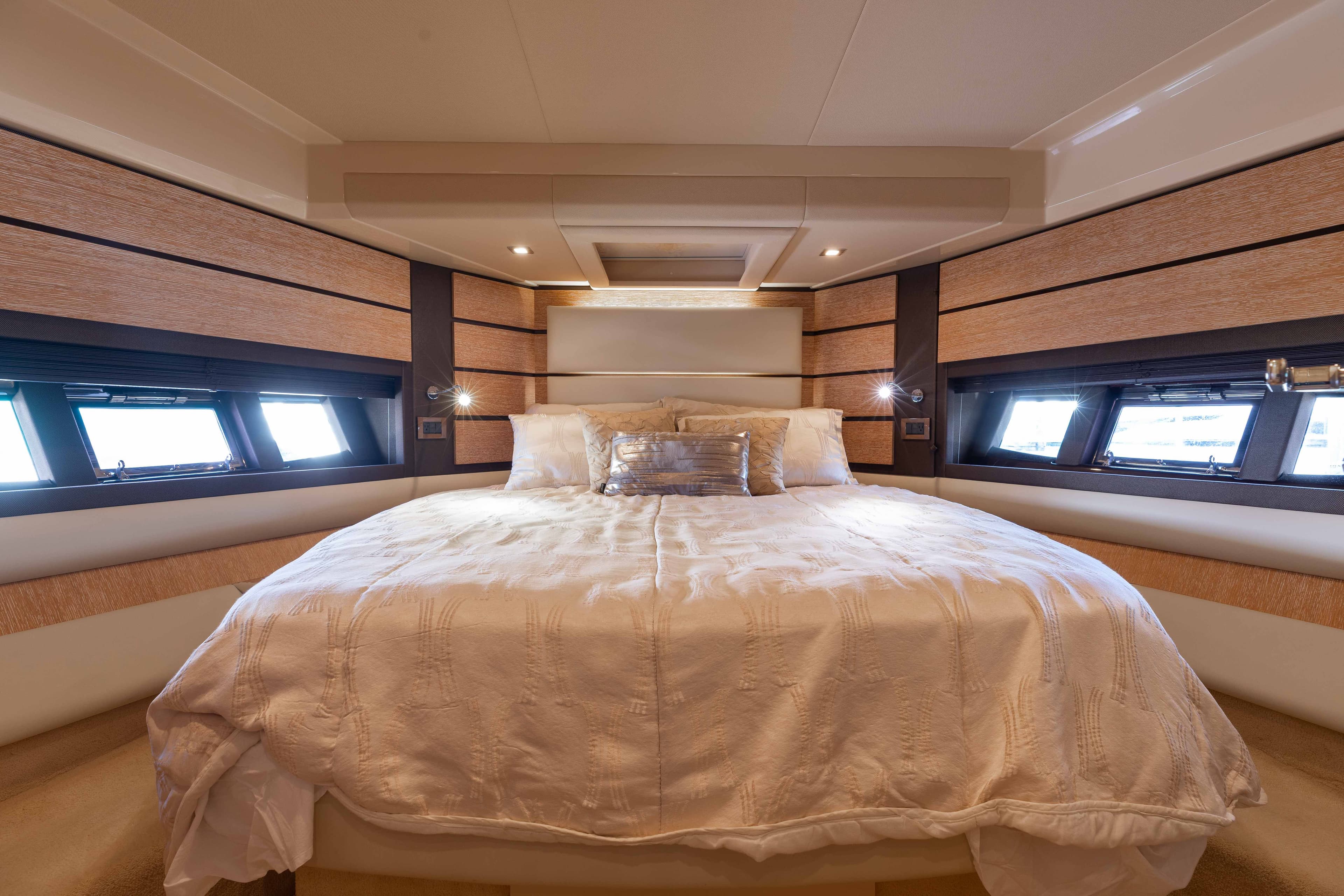 Luxurious bedroom interior of 2014 Azimut 60 Flybridge yacht with elegant bedding and modern design.
