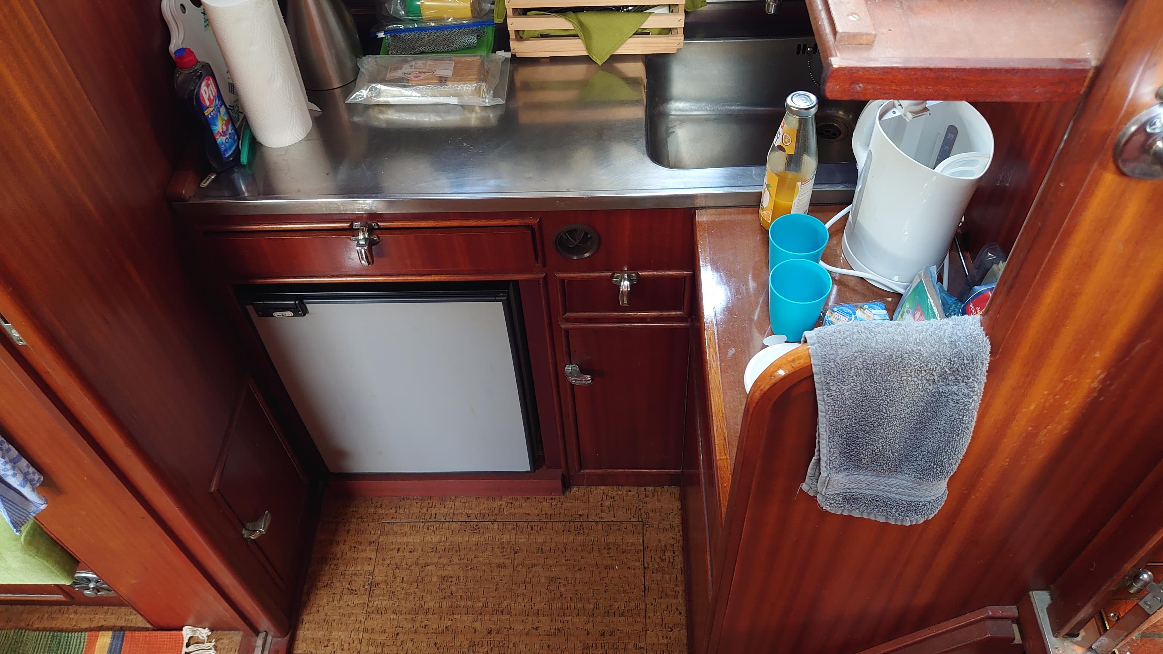 1972 Holland Kreuzer Gebr. Visch boat kitchen with wooden cabinets and stainless steel sink.