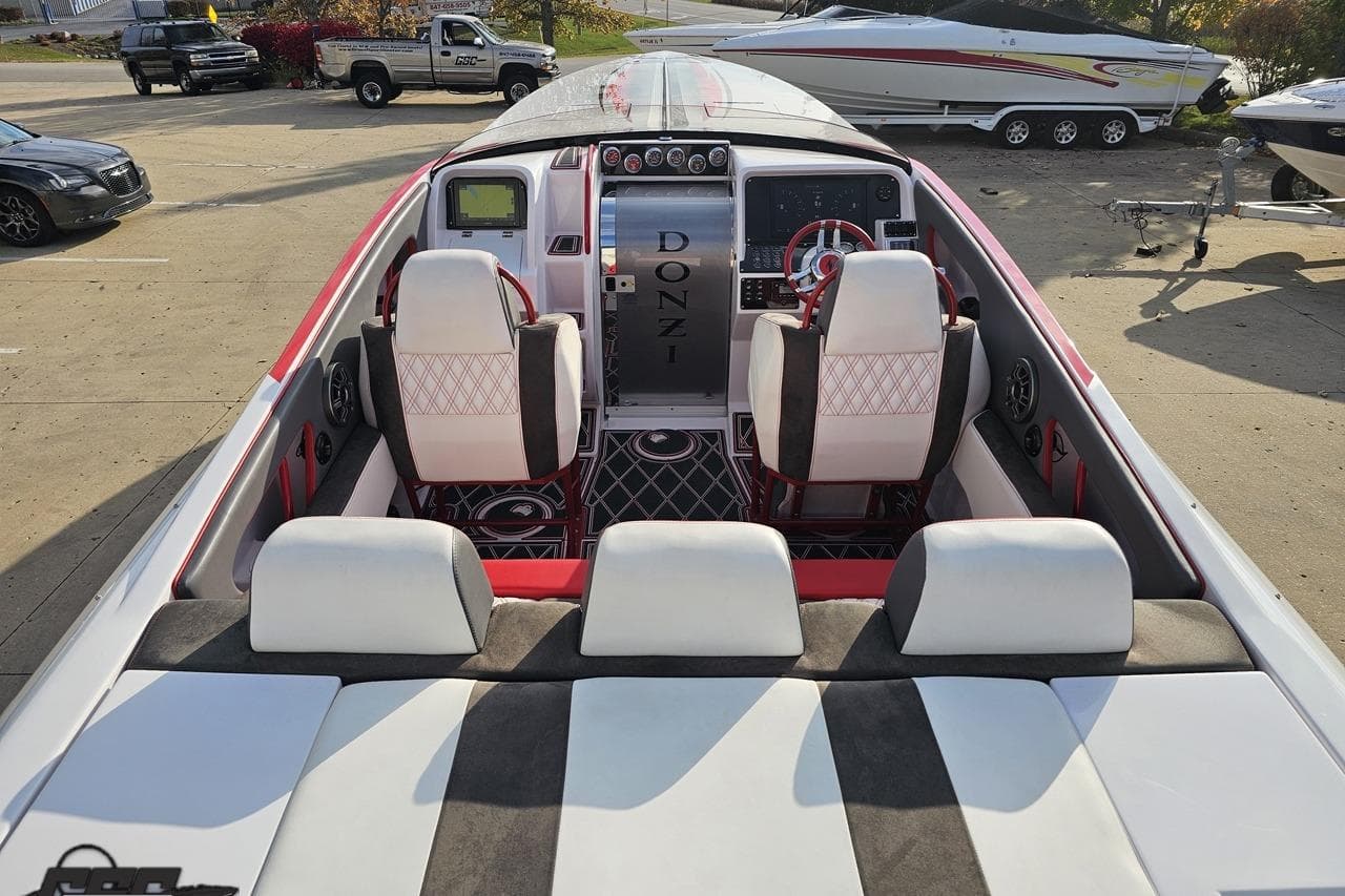 2008 Donzi 38 ZR speedboat interior with white and red seating, dashboard, and steering wheel.