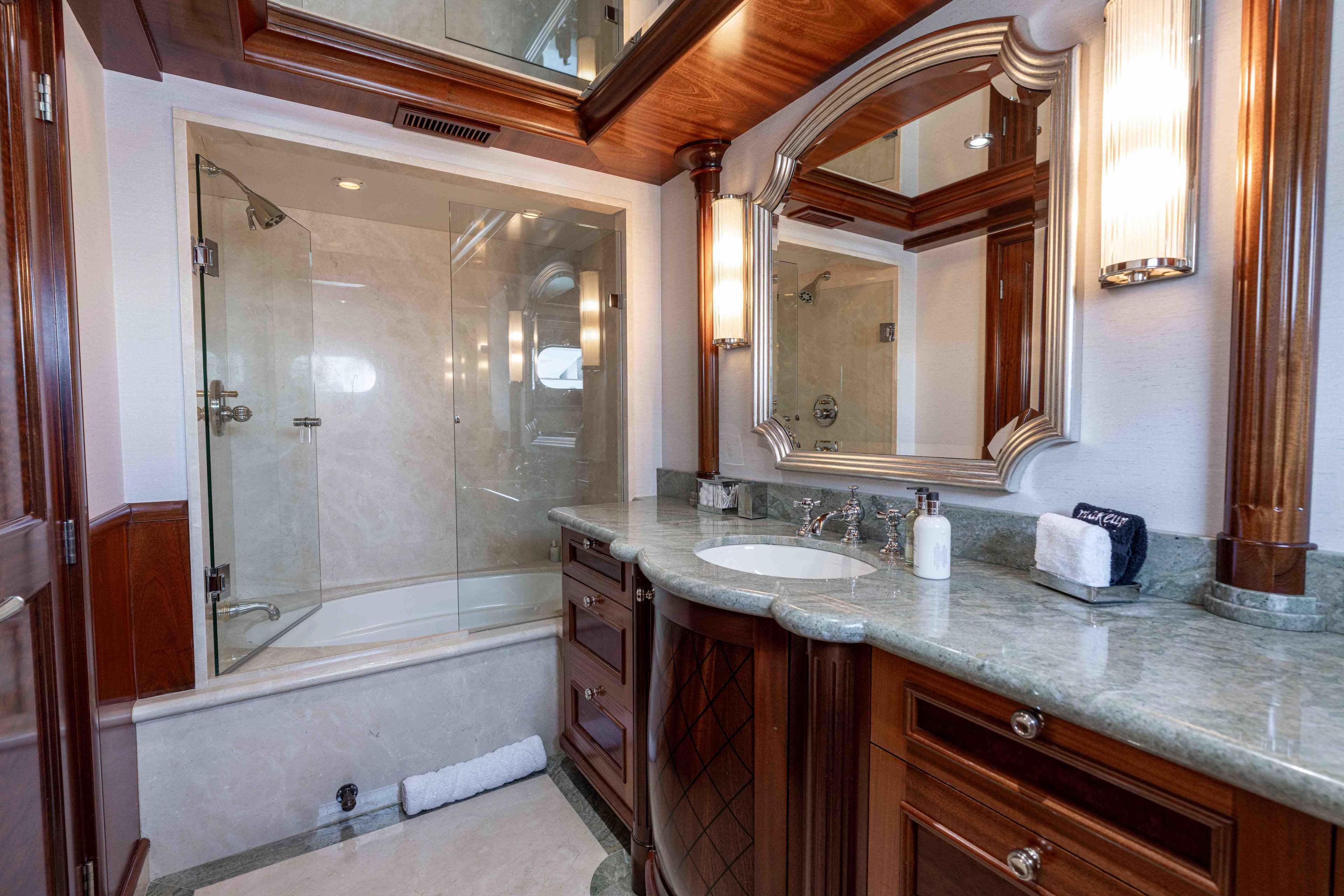 Luxurious bathroom on Richmond Yacht 2008 with marble and wood accents.