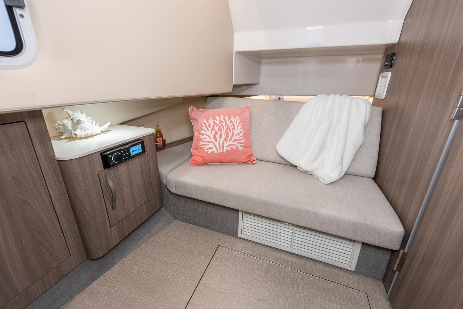 Manufacturer Provided Image: 2026 Regal 33 SAV cabin interior with cozy seating, coral pillow, and modern cabinetry.
