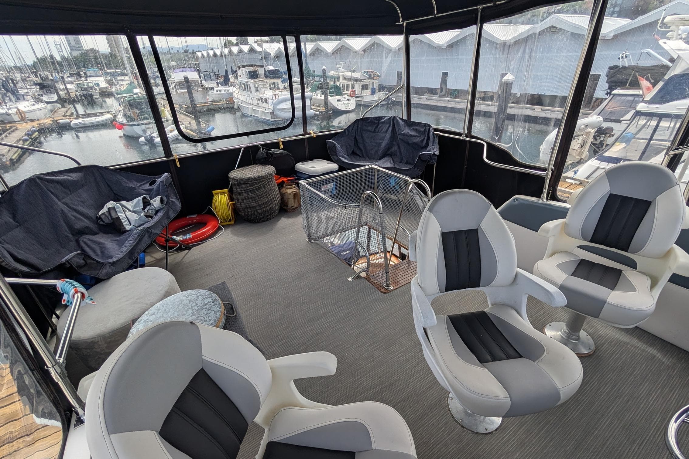 1990 Bayliner 3888 Motoryacht interior with seating, overlooking marina and boats.
