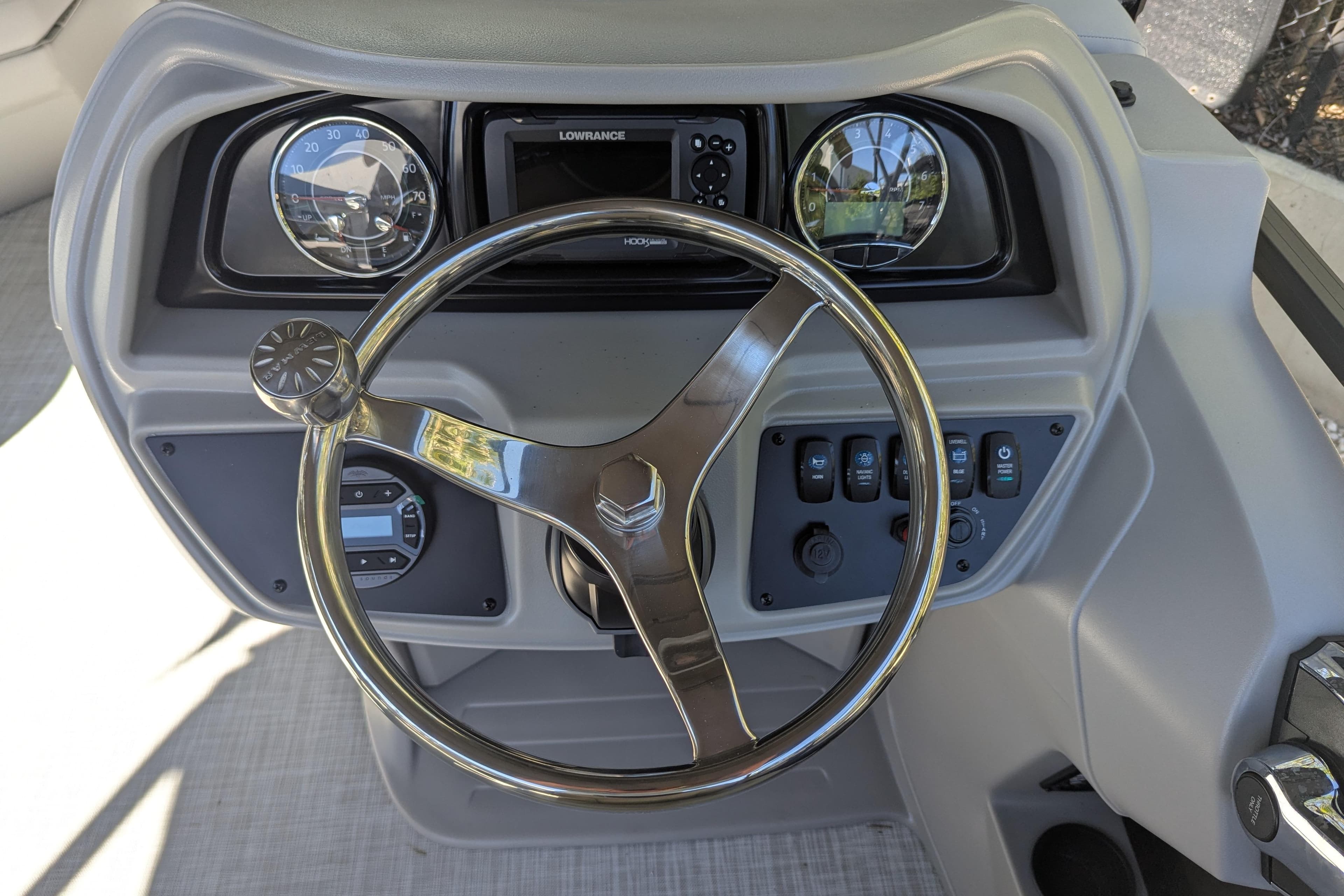 Steering console of 2026 Dockside 22DQ2.75 boat with gauges and controls.