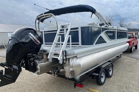 2026 Sweetwater 2286C pontoon boat with Mercury outboard engine on trailer.