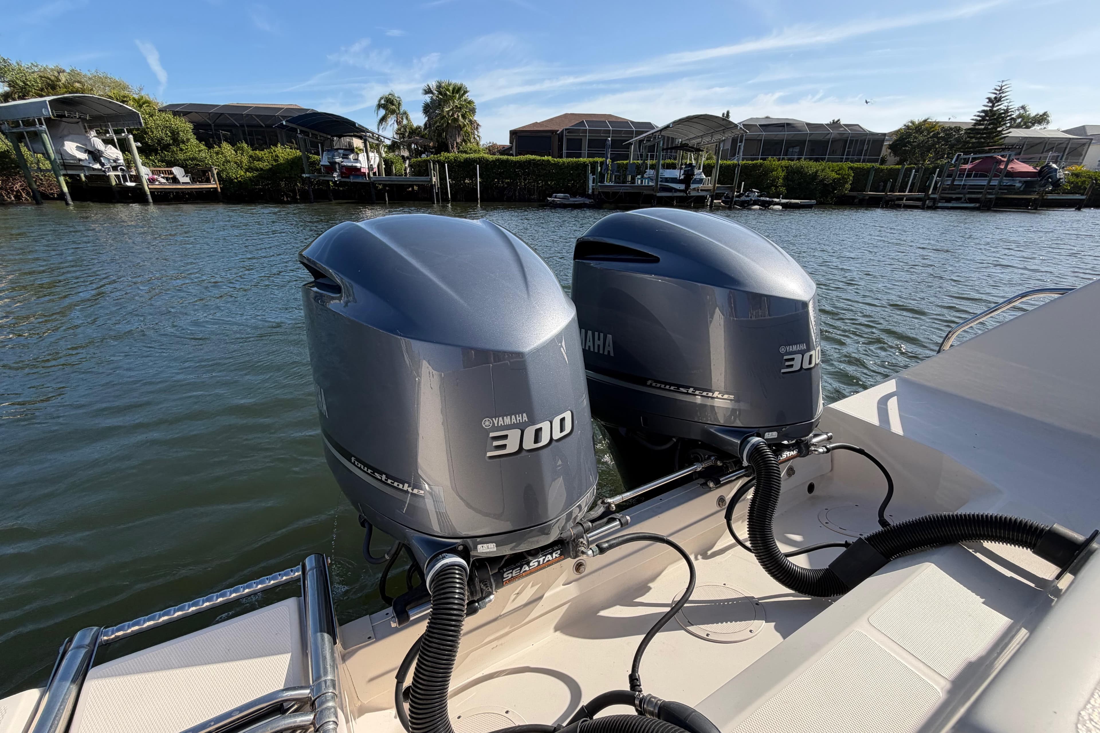 2018 Grady-White Canyon 306 with twin Yamaha 300 engines on a sunny waterfront.