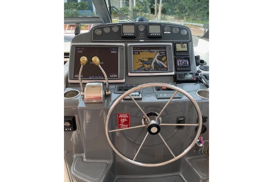 Helm of 2004 Tiara Yachts 3600 Sovran with navigation screens and controls.