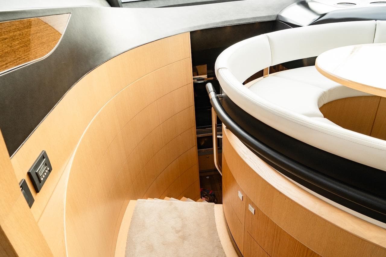 Luxurious interior of 2012 Princess V72 yacht with elegant wood and leather seating.