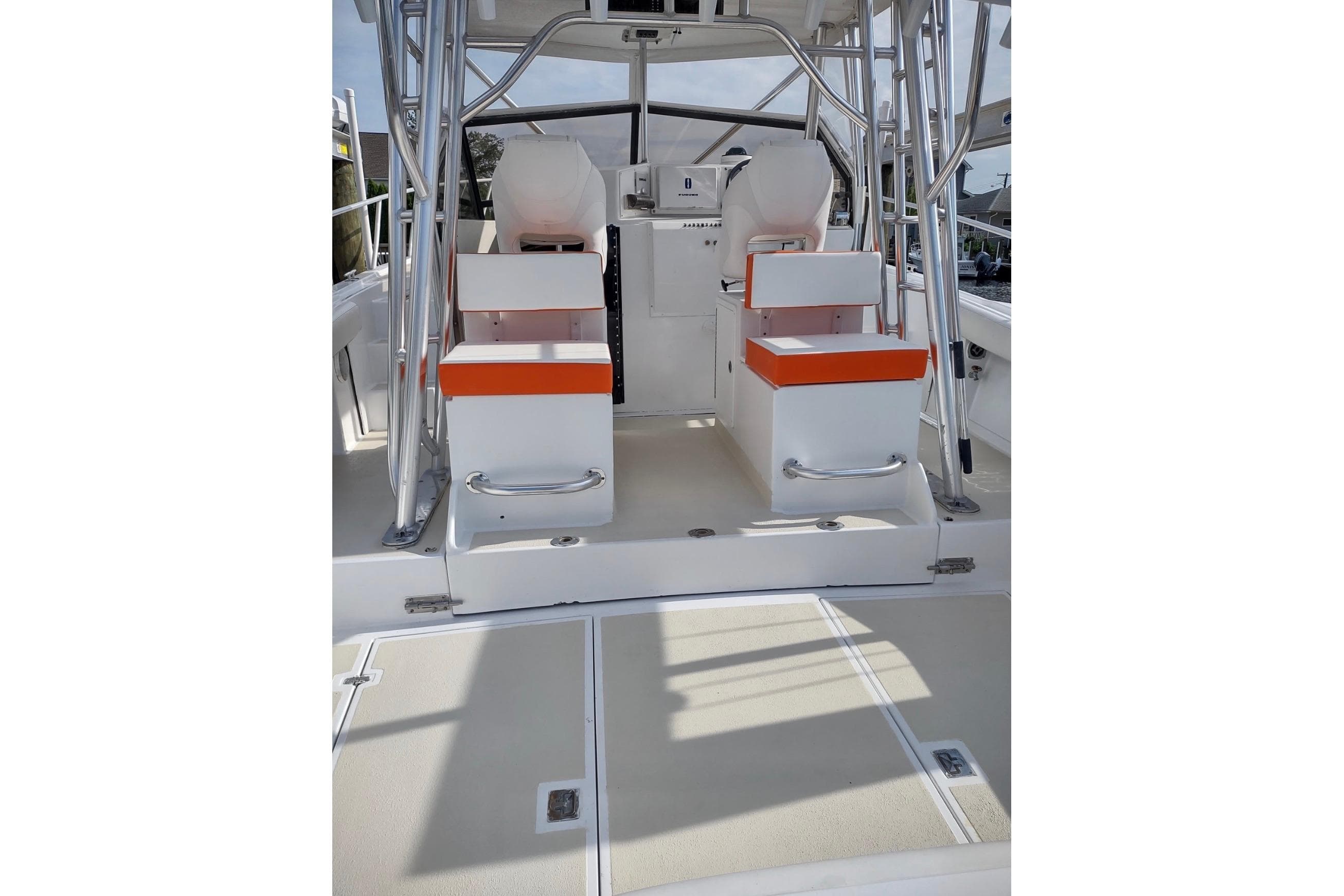 1990 Orca 36 boat interior with dual seating and orange accents.