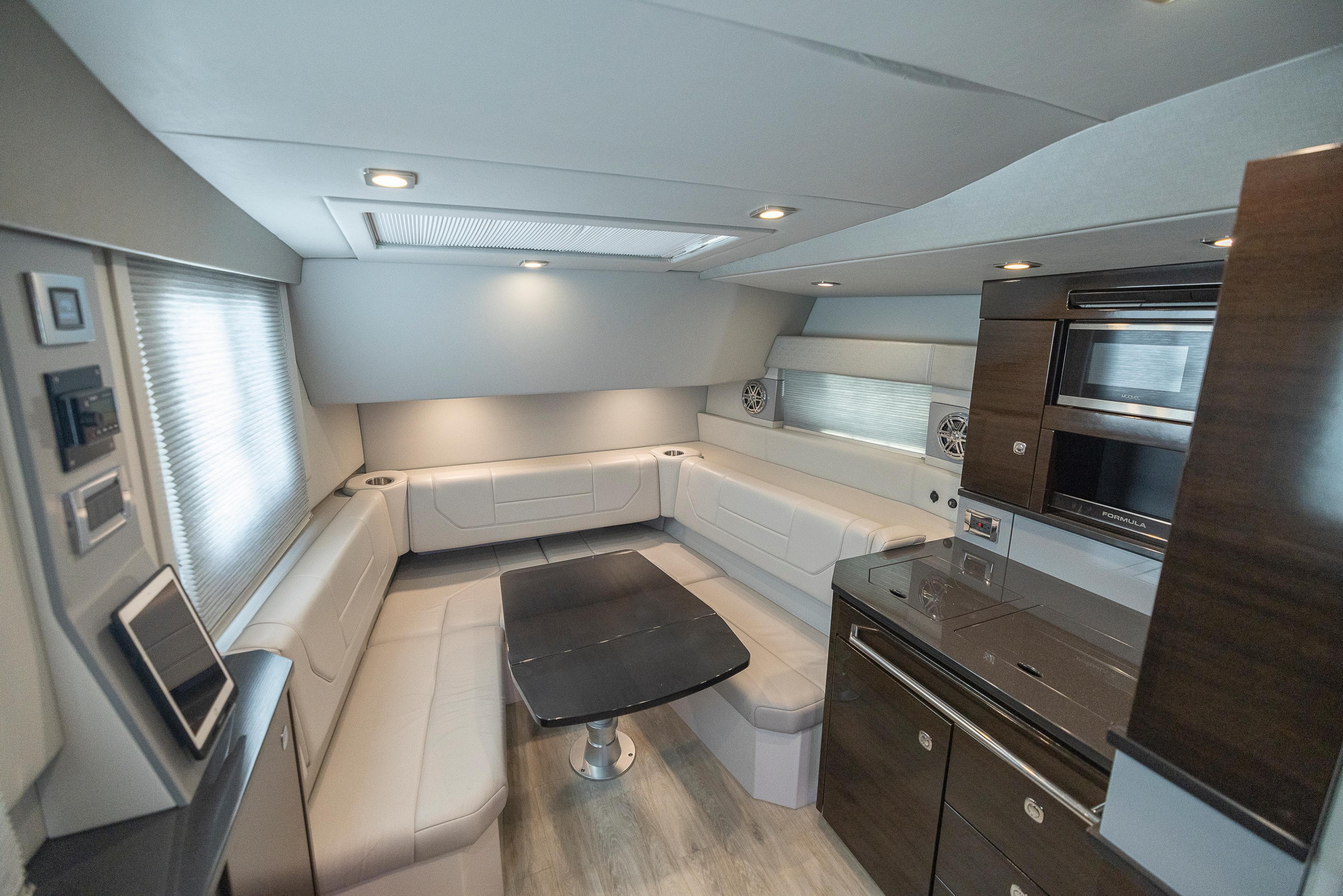 Luxurious interior of 2019 Formula 430 Super Sport Crossover yacht with modern seating and cabinetry.