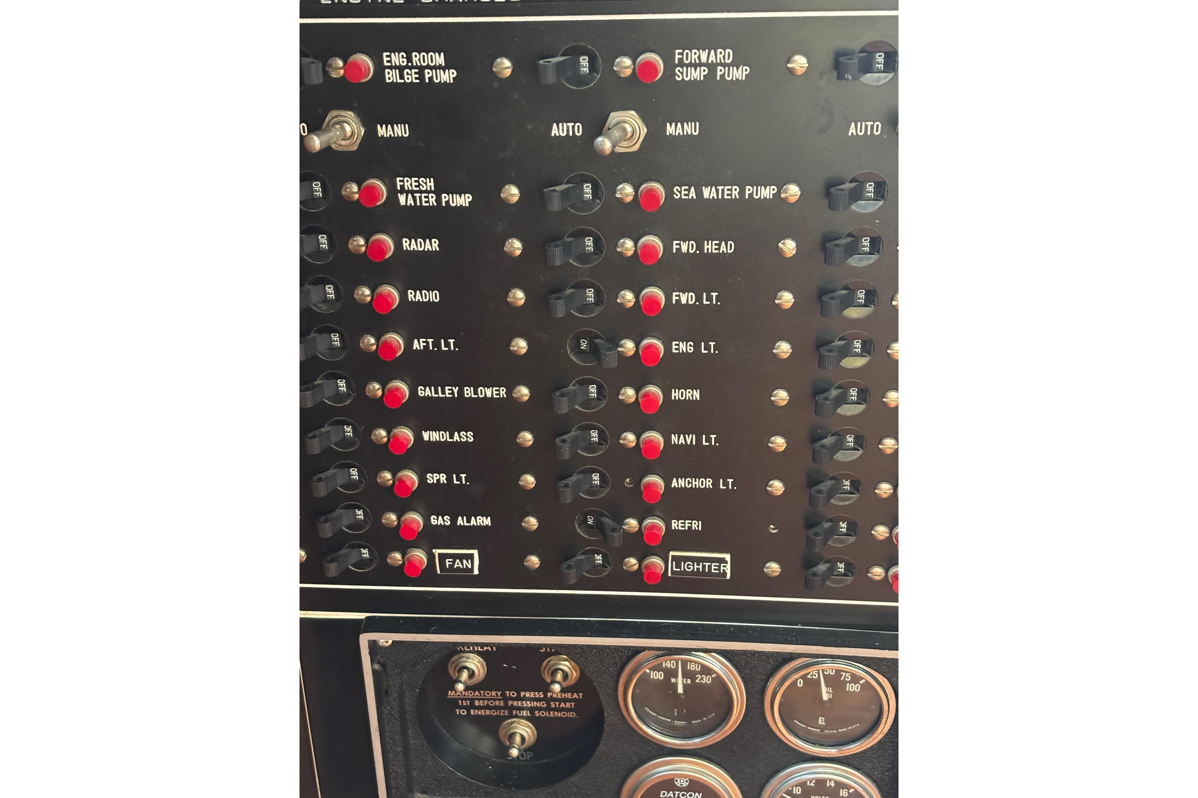 Control panel of a 1984 Ocean Alexander 38 Double Cabin yacht with various switches and gauges.