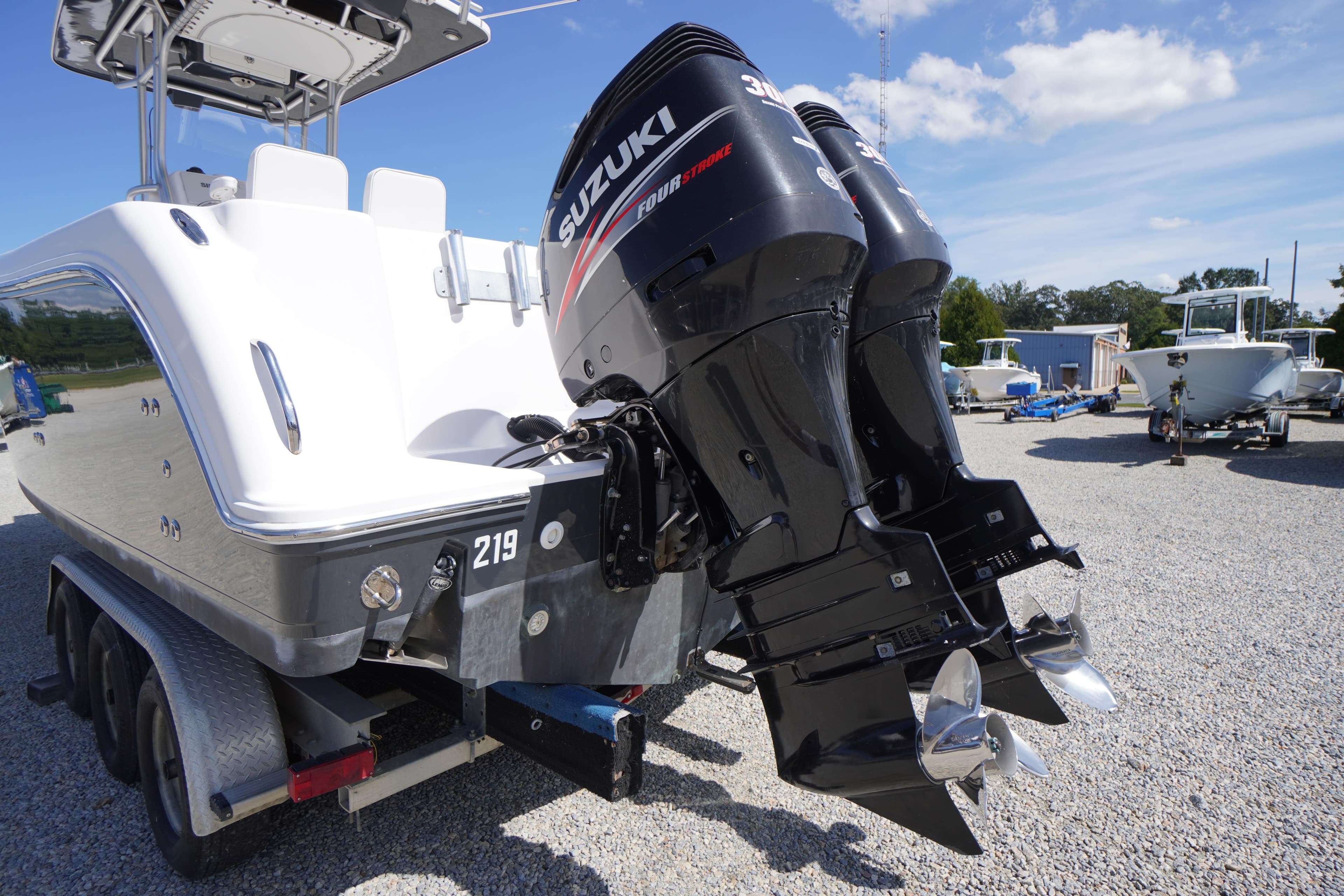 2016 Pro-Line 29 Grand Sport boat with dual Suzuki outboard motors on a trailer.