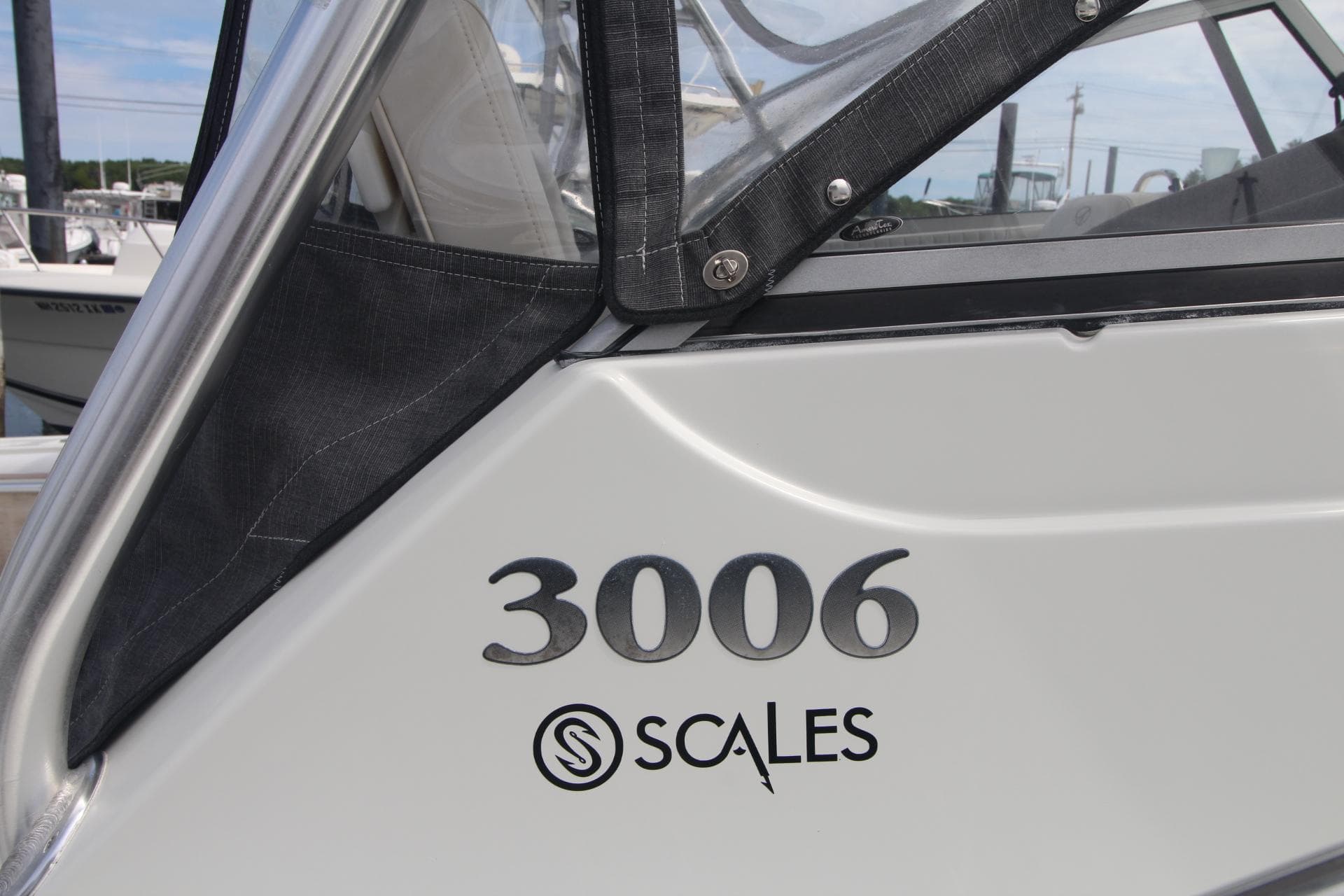 2007 Sailfish 3006 WALKAROUND boat detail with Scales logo, docked.