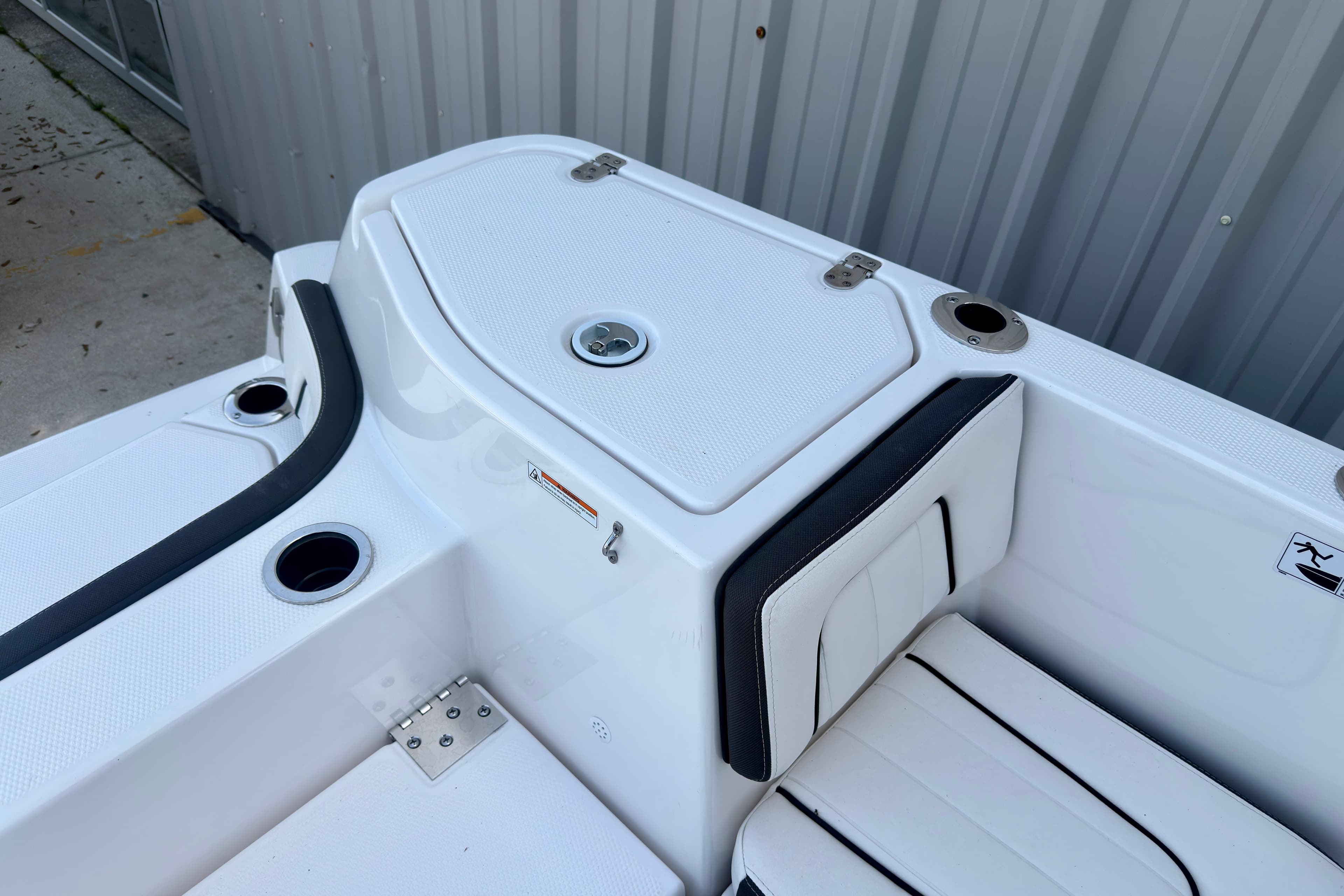 2026 Yamaha Boats 255 FSH Sport H, featuring sleek white seating and storage compartments.
