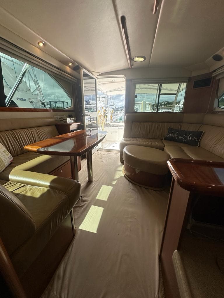 Luxurious interior of 2004 Riviera 37 Convertible yacht with plush seating and elegant decor.