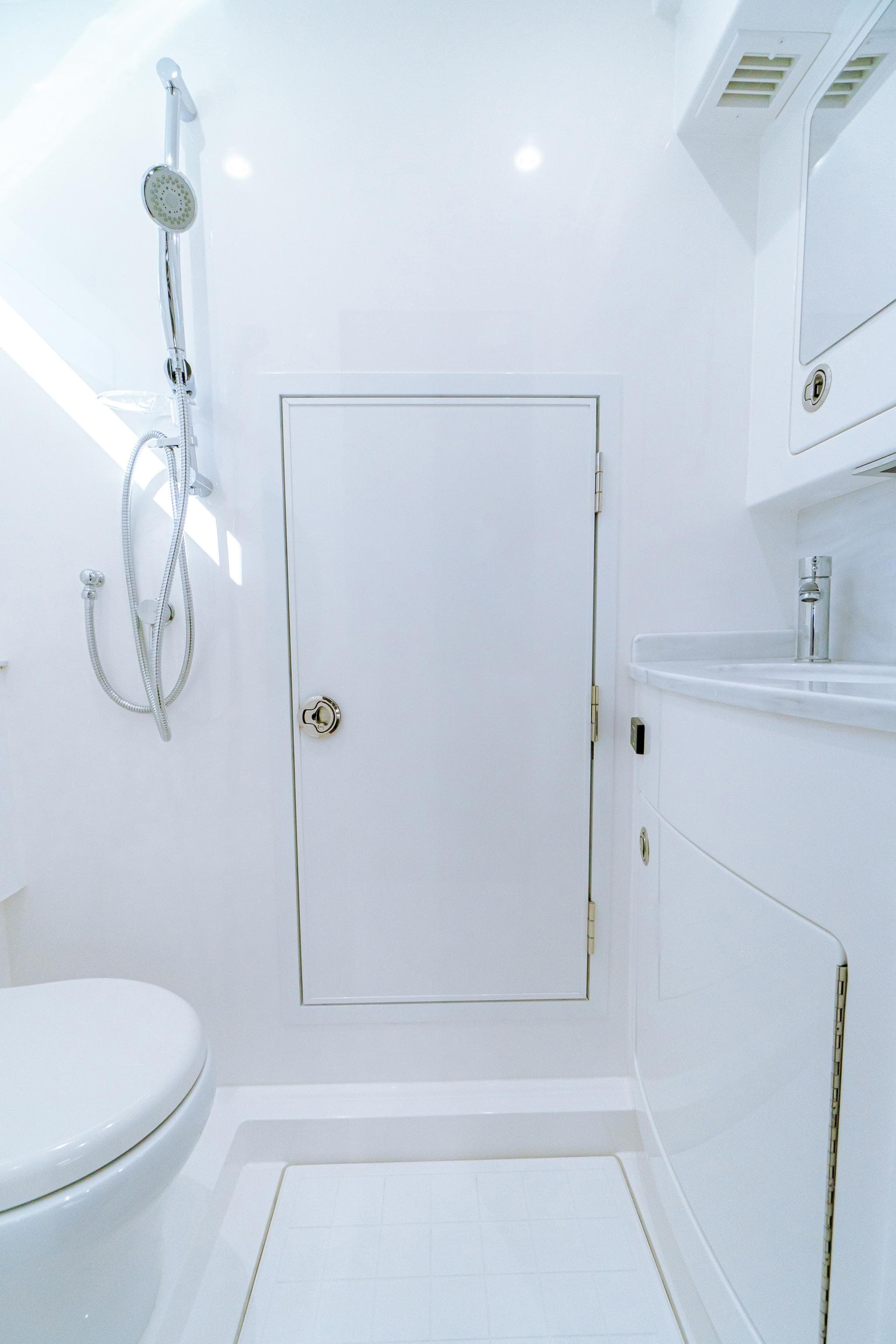 2025 Valhalla Boatworks V-46 bathroom with modern fixtures and sleek white design.