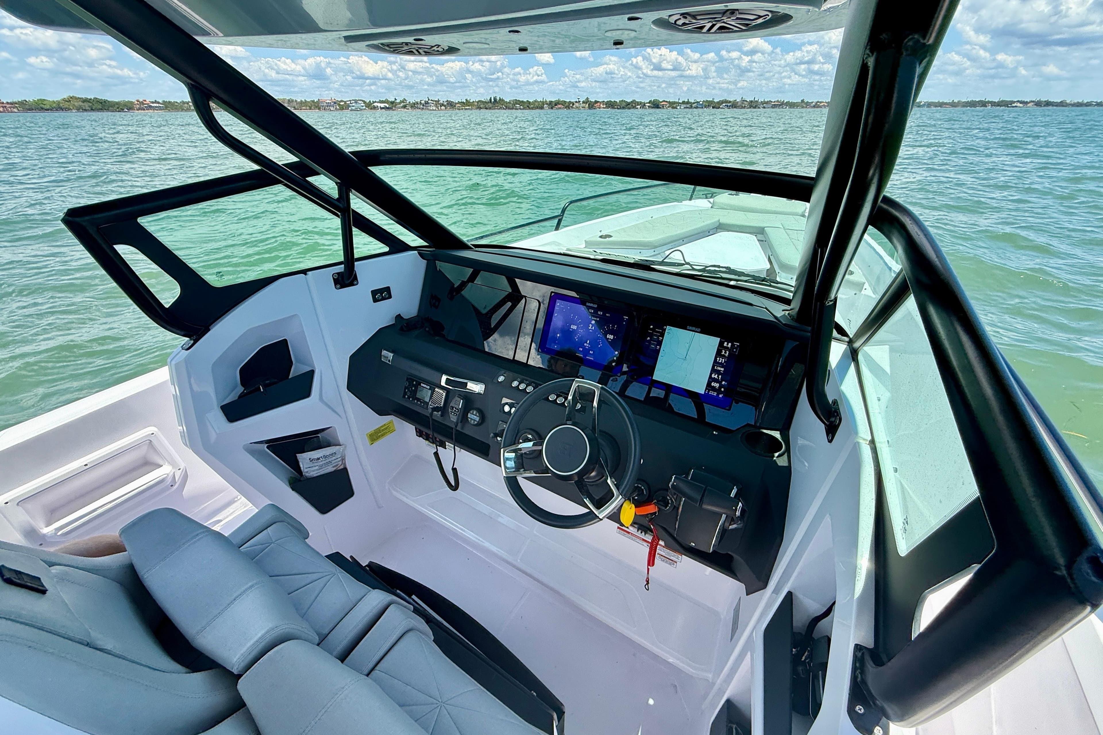 2025 Axopar 29 Sun-Top boat interior with modern dashboard and steering wheel.