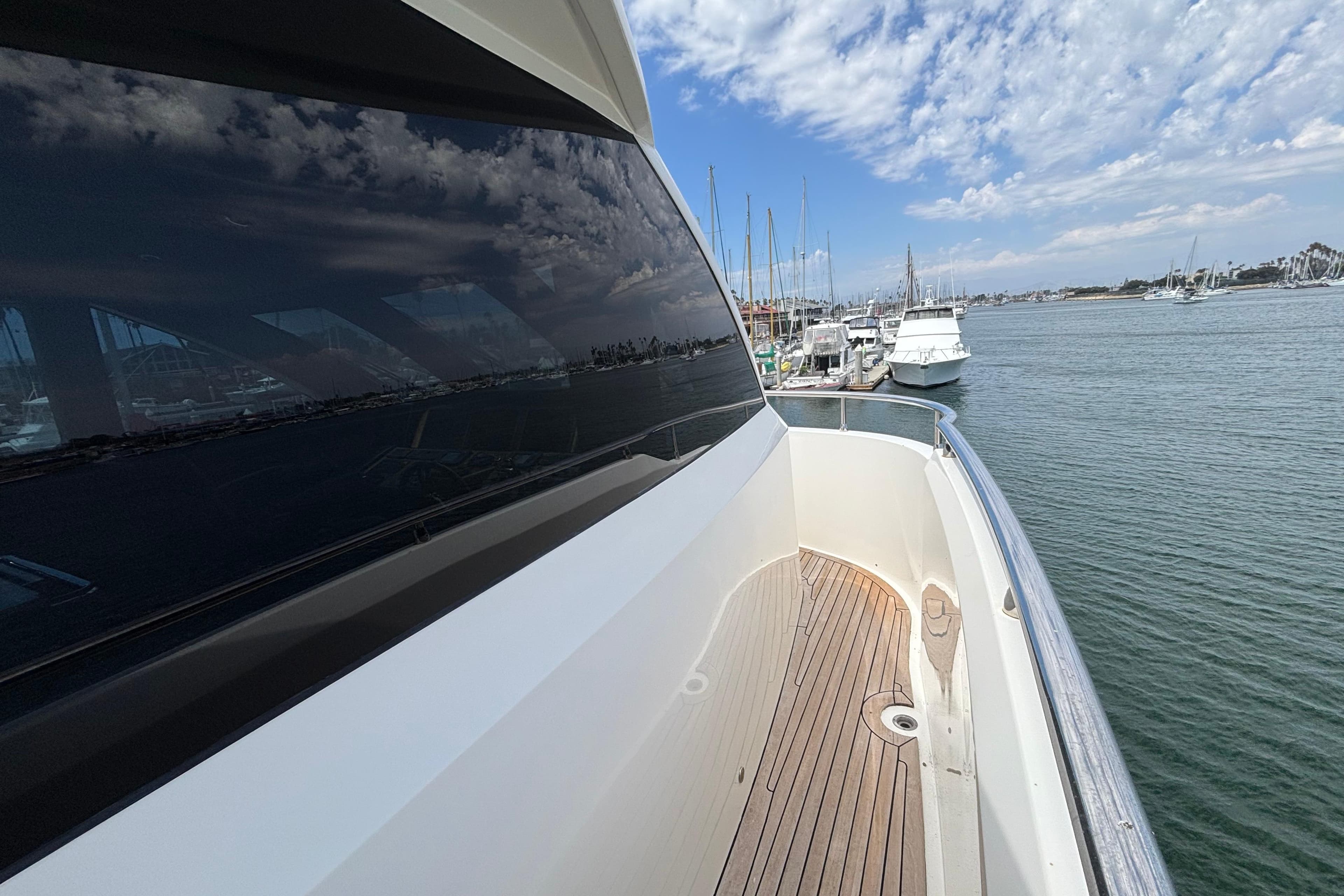2010 Norseman 80 yacht docked at marina, reflecting sky and water.