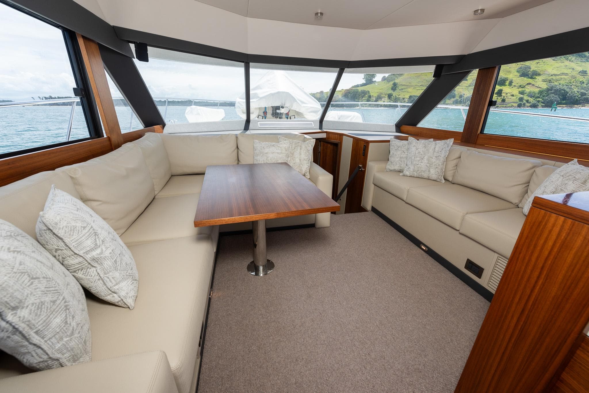 Luxurious interior of 2021 Maritimo M51 yacht with spacious seating and elegant wood finishes.