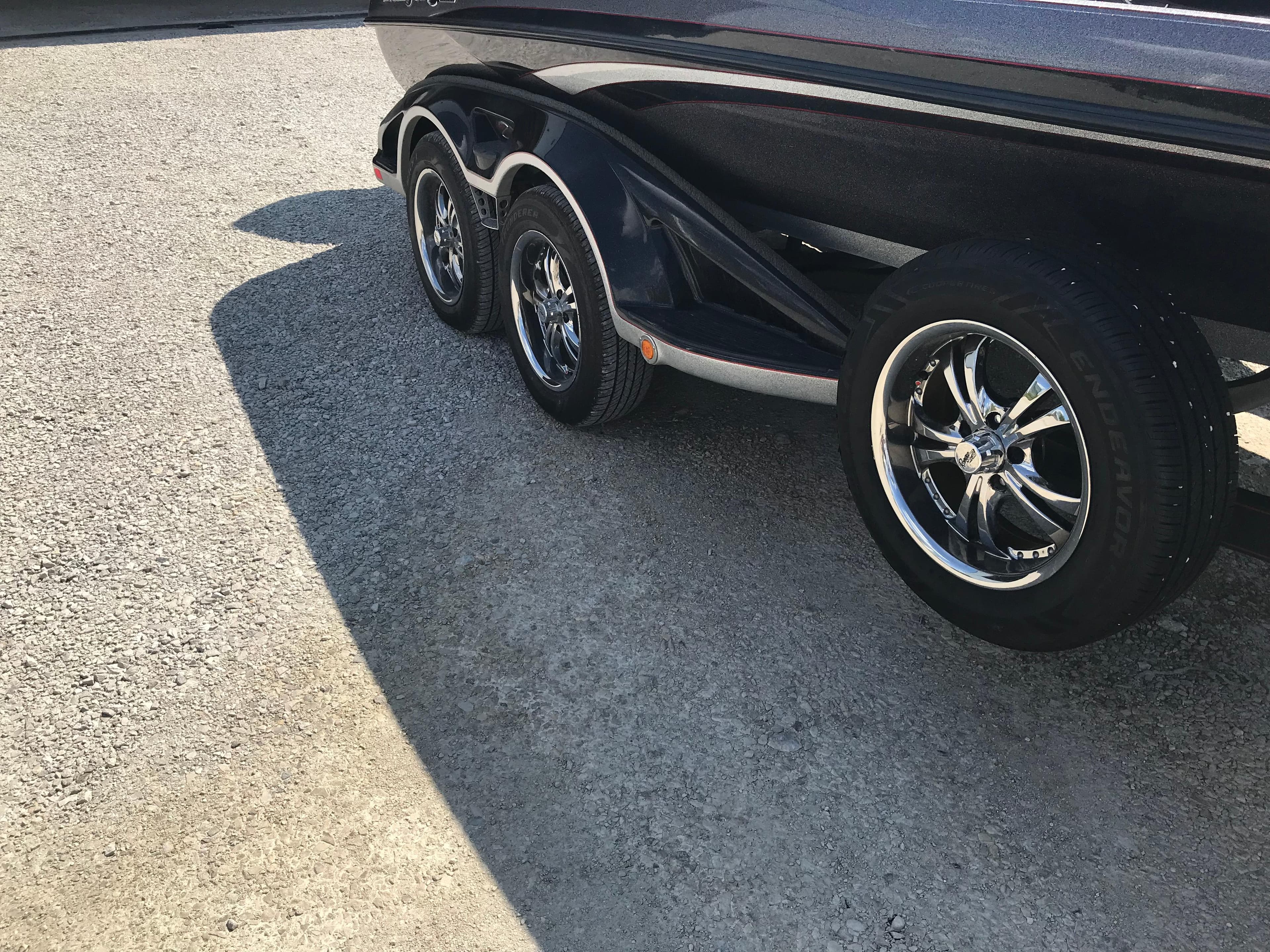2017 Ranger Z520 Comanche boat trailer with shiny chrome wheels on a sunny day.