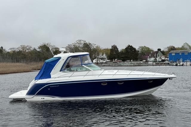 2006 Formula 40 Performance Cruiser on calm water, featuring sleek blue and white design.