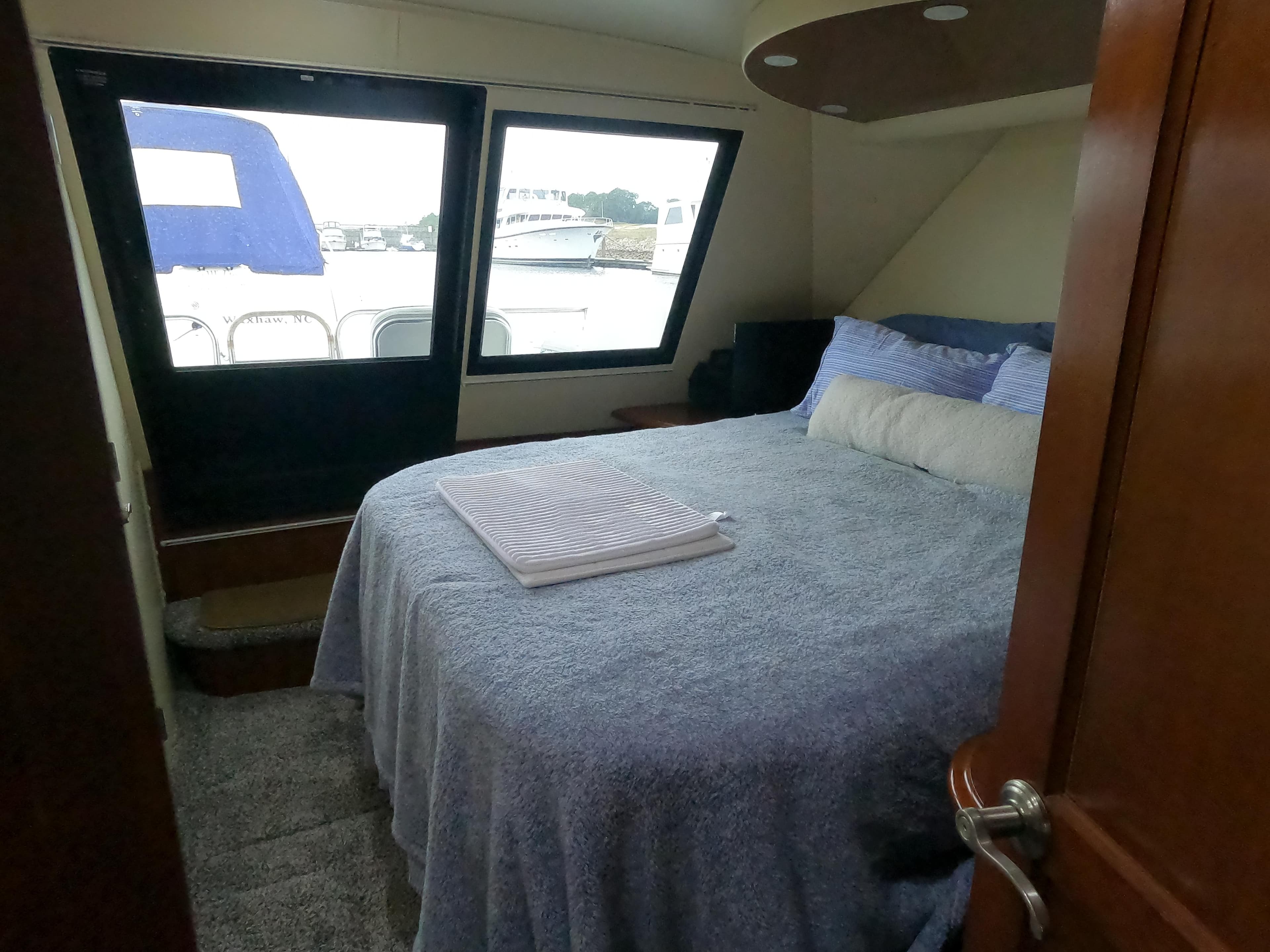 Bedroom interior of 2006 Bluewater Yachts 5200 with large bed and window view.