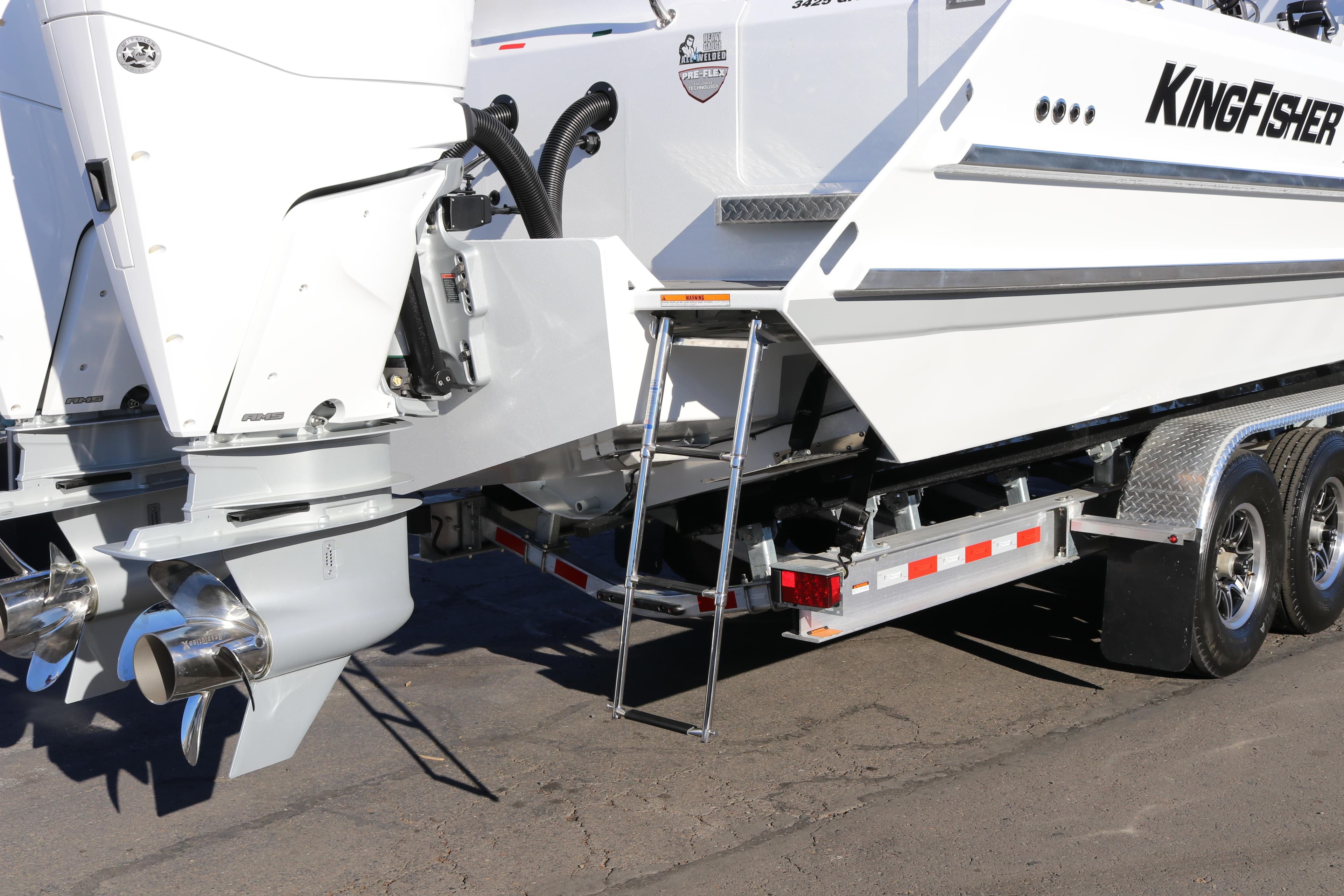 KingFisher 3425 GFX Offshore 2026 boat on trailer, featuring dual outboard motors.