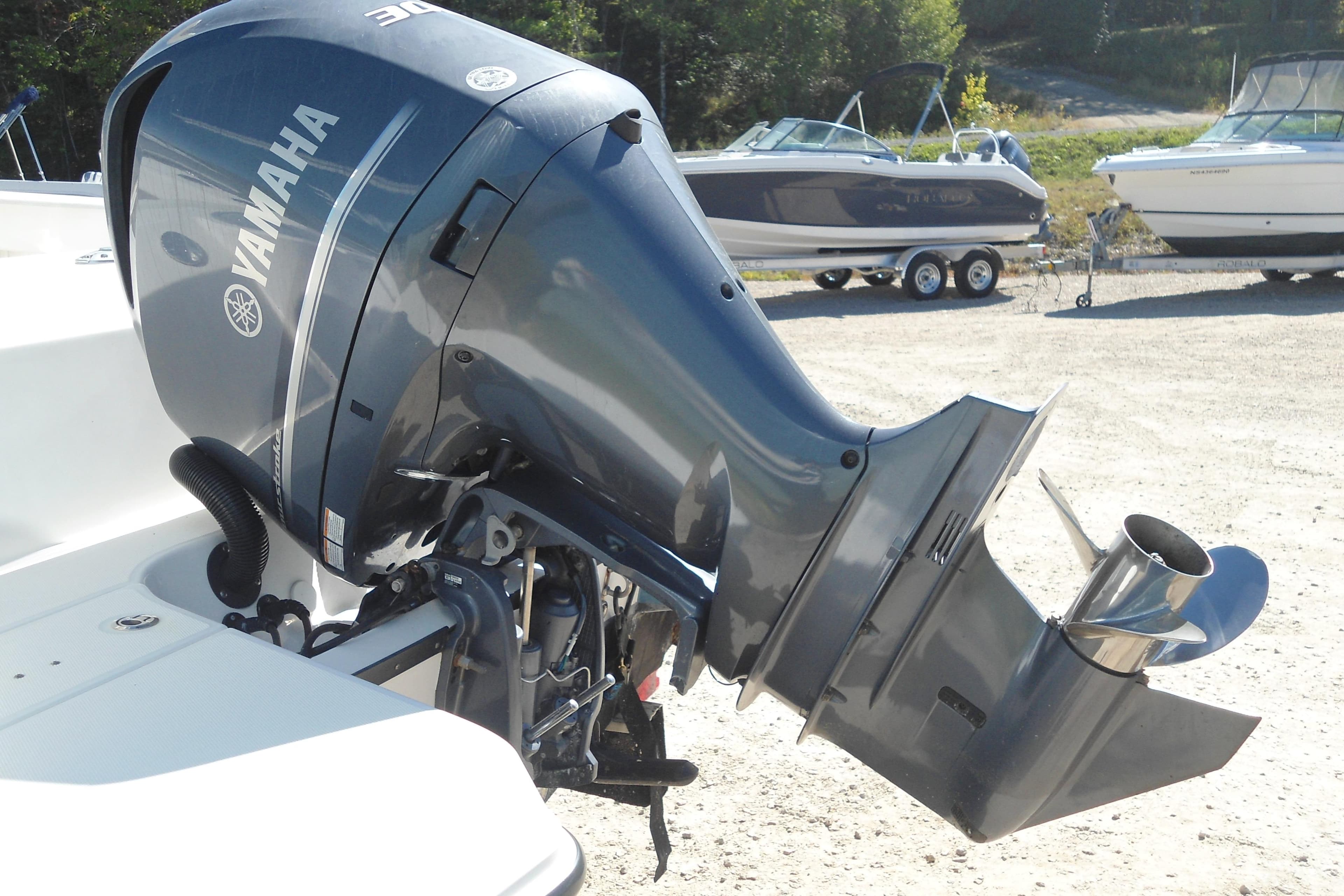 2019 Edgewater 230CC with Yamaha outboard motor in a boatyard setting.