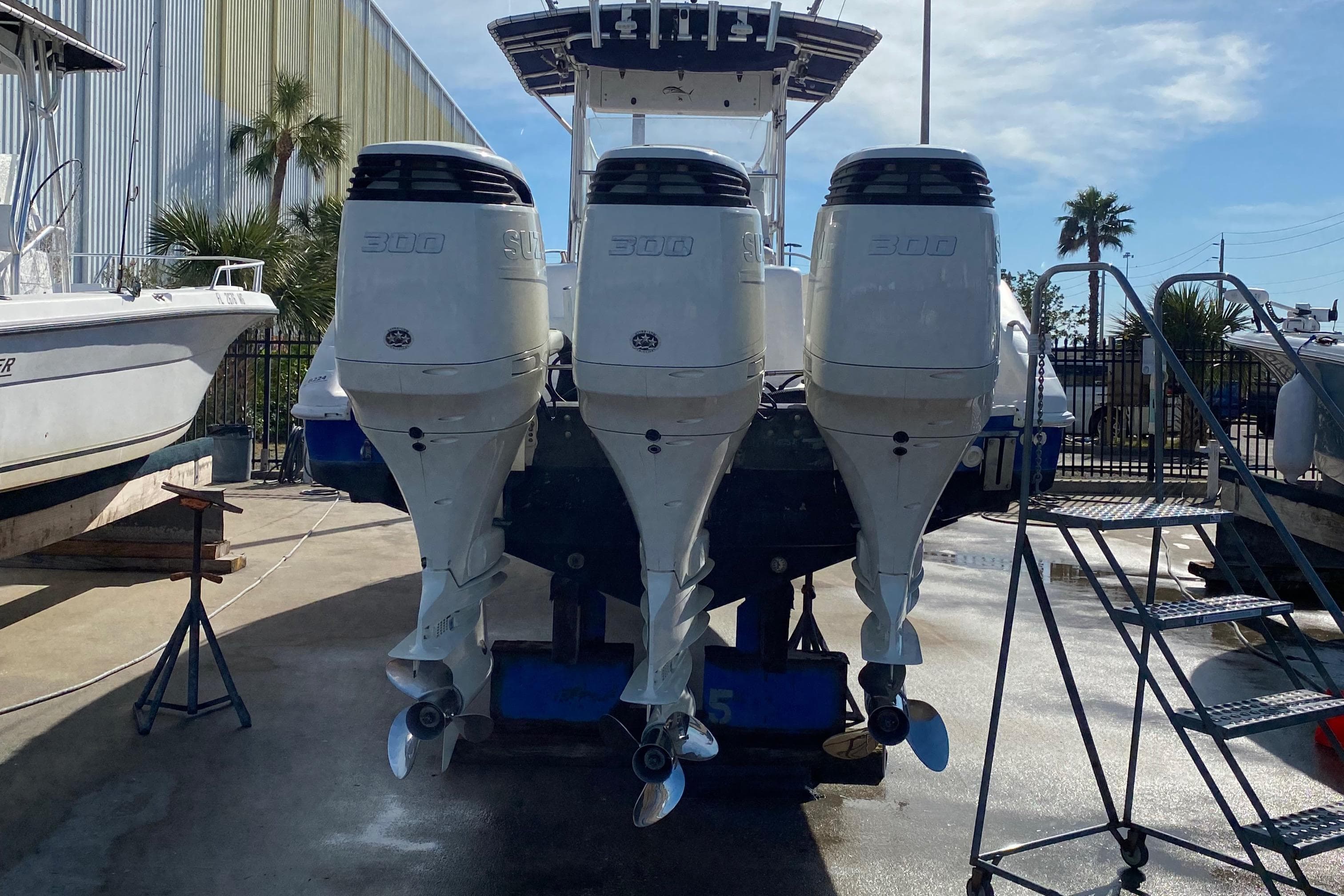 2000 Donzi 35 ZF Open with triple outboard engines in a marina setting.