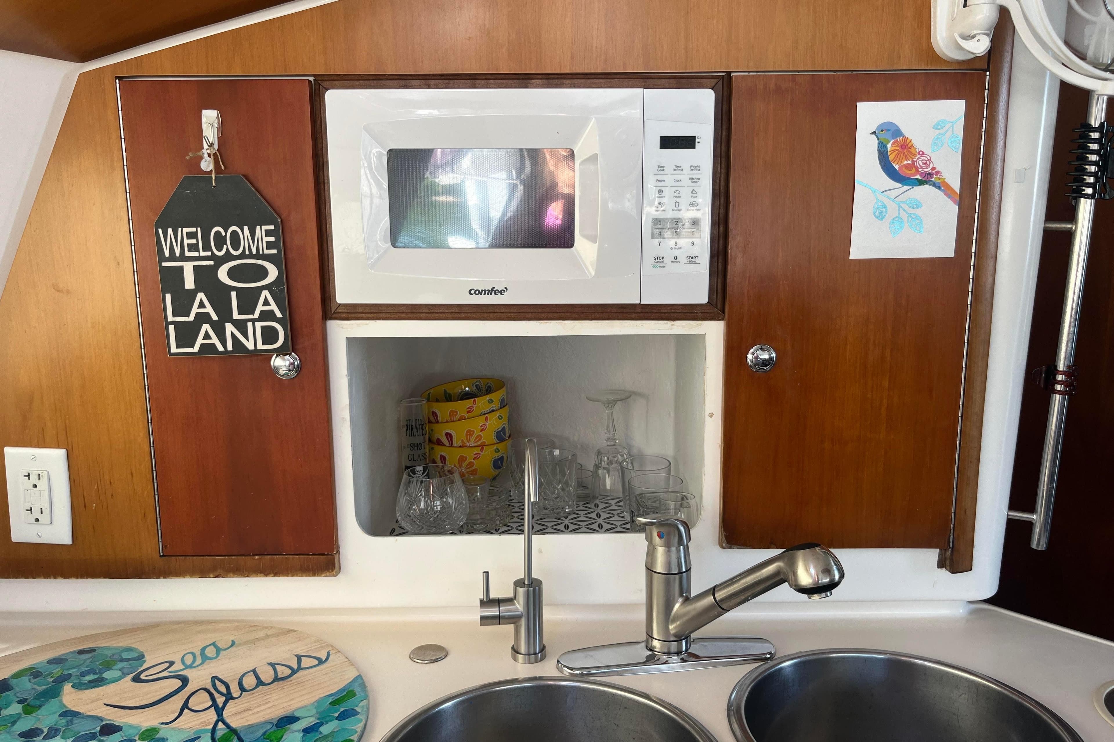 Galley of 2000 Fountaine Pajot Belize 43 with microwave, sink, and decorative elements.