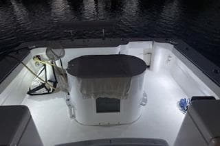 2004 Luhrs 38 Open boat deck illuminated at night, showcasing fishing equipment.