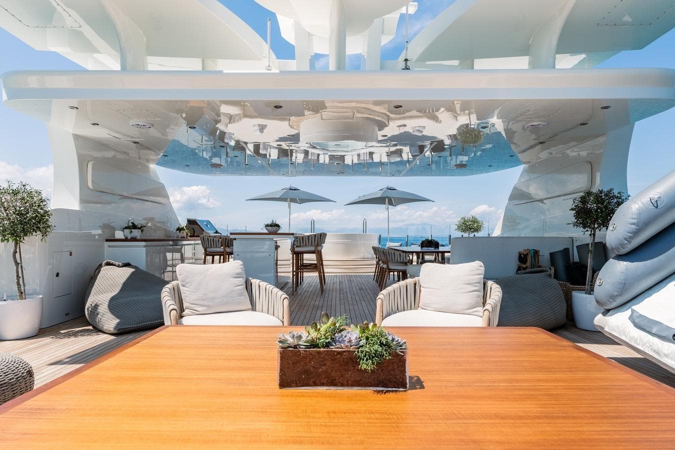 Luxurious Ortona Navi yacht deck with elegant seating, plants, and ocean view, 2008 model.