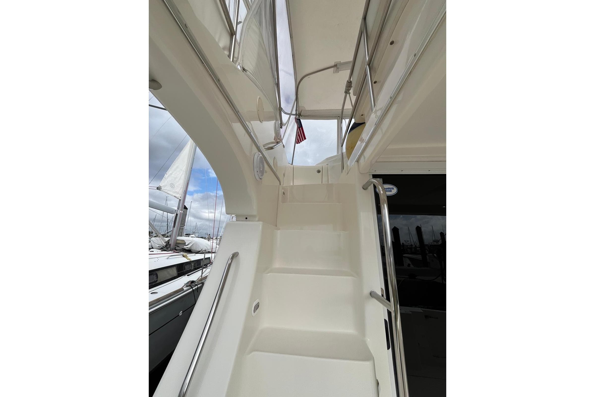 Staircase on 2005 Silverton 34 Convertible yacht with railing and overhead view.
